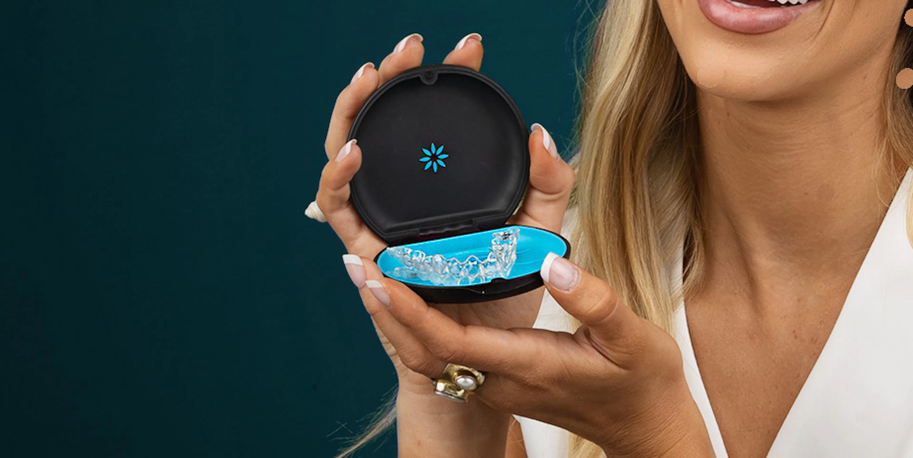 Patient Zoe Creed Smiling with Invisalign Aligners and case