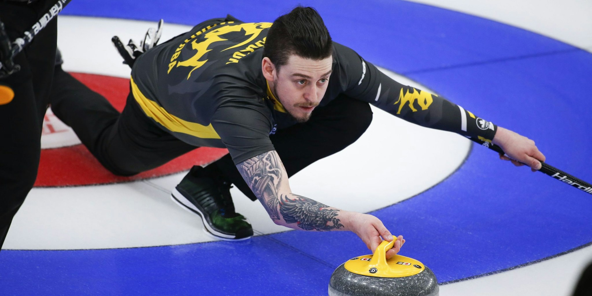 Colin Hodgson releasing a curling rock during a match