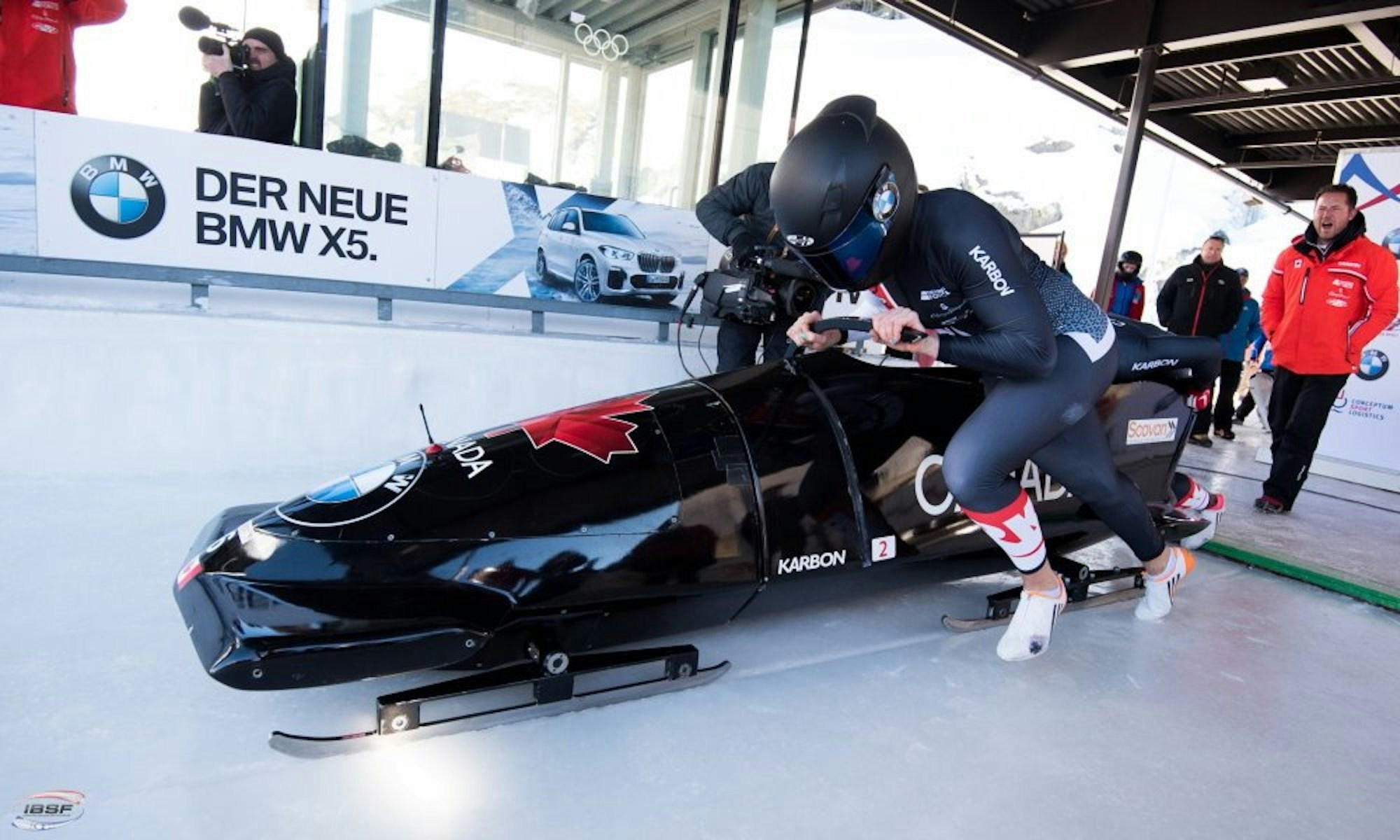 An action shot of Alysia Rissling pushing a bobsled.