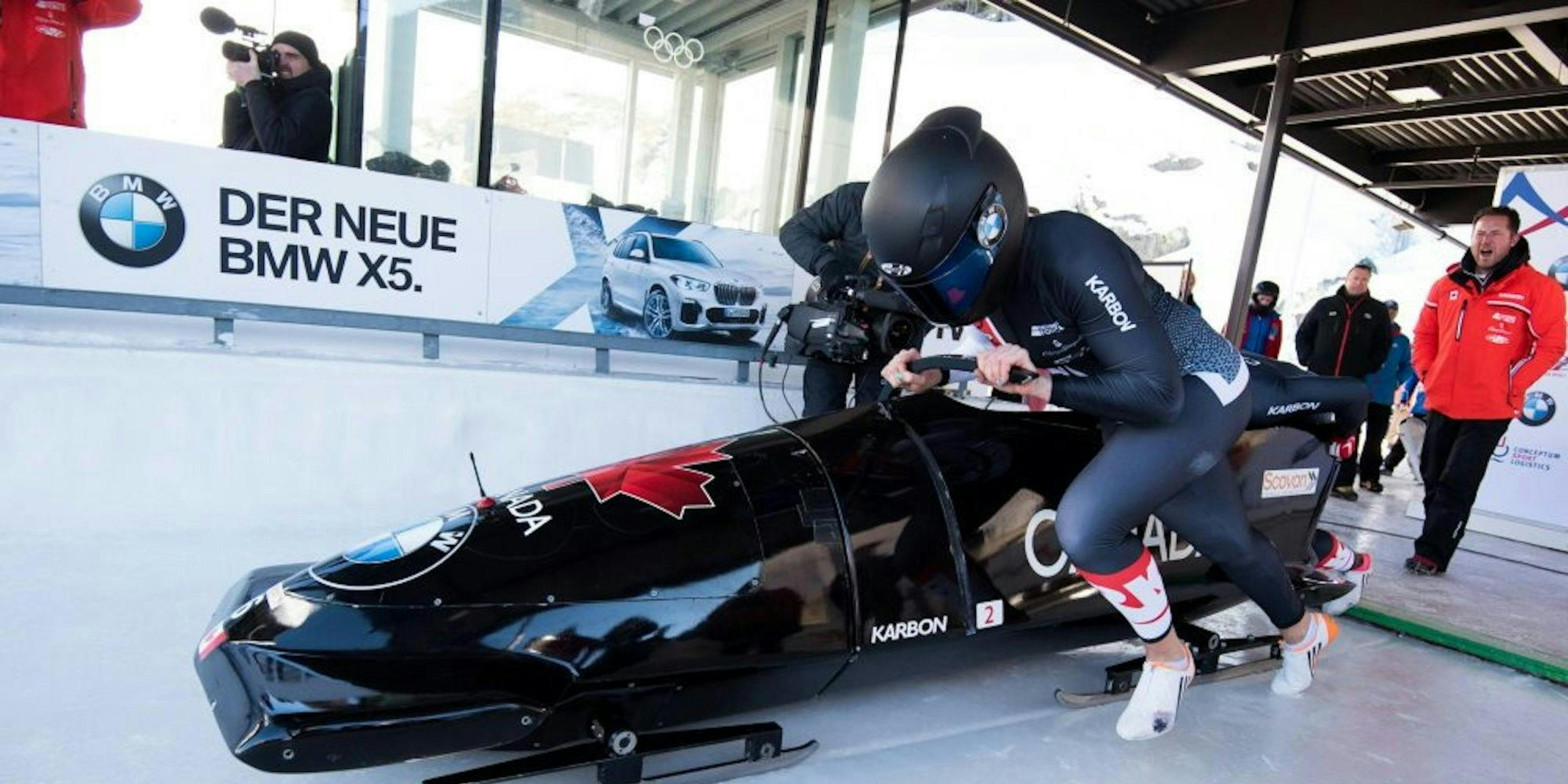 An action shot of Alysia Rissling pushing a bobsled.