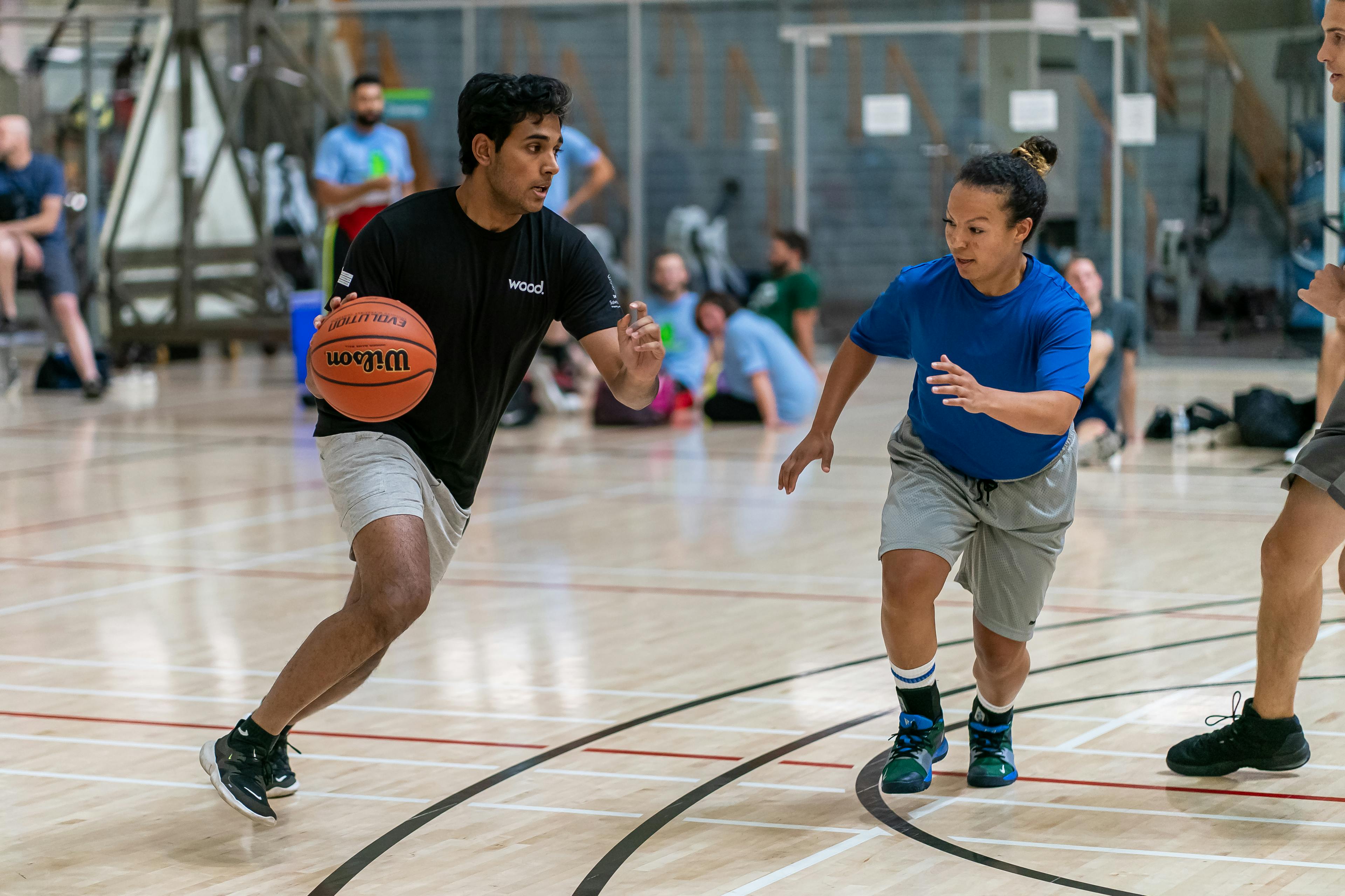 Two people playing basketball