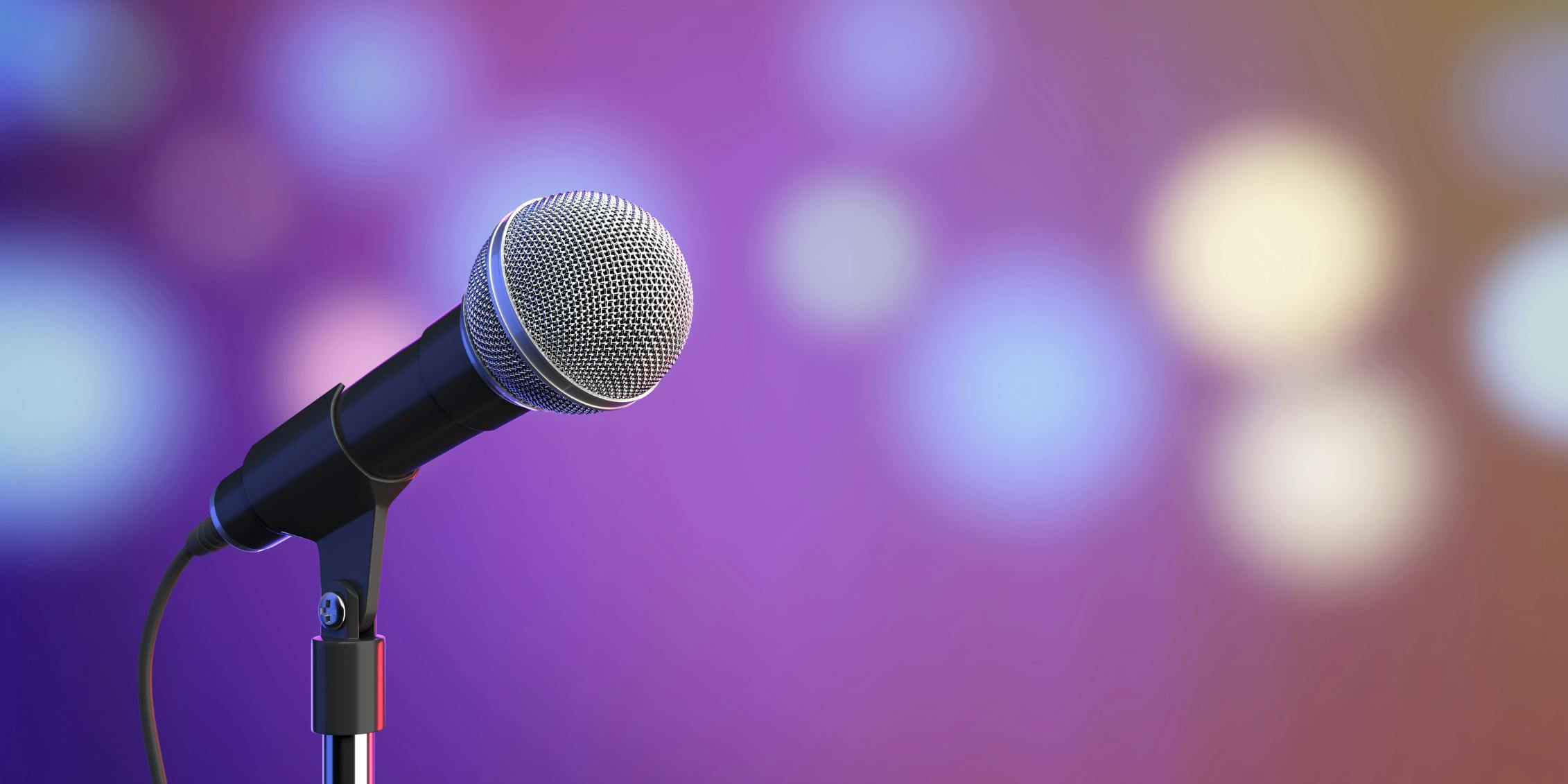 close up of a microphone with a background of blurred lights