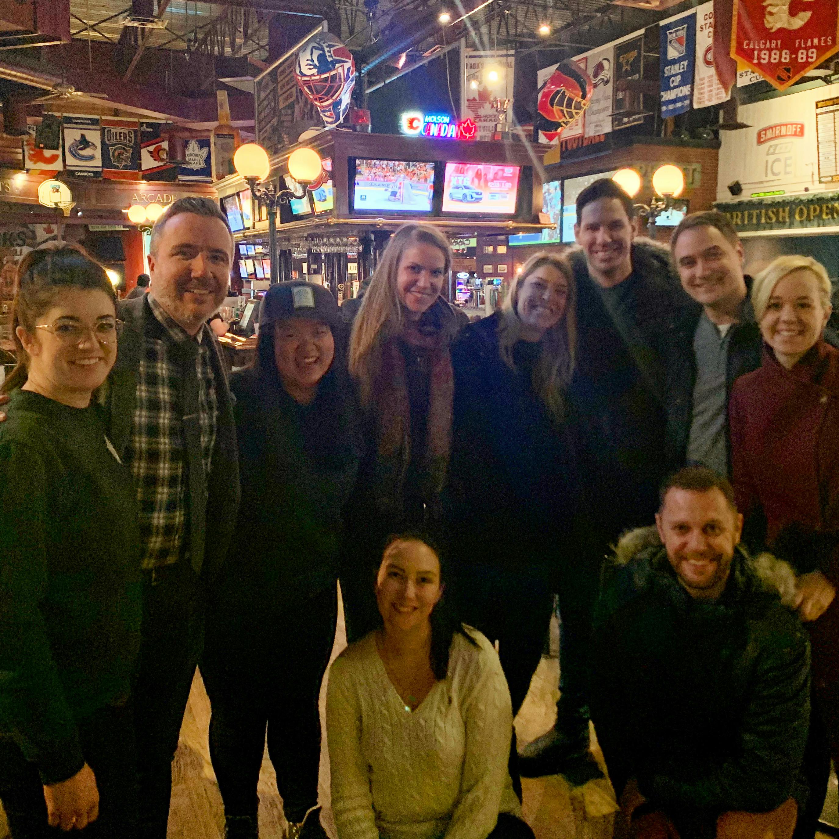 a group of 10 people posing at schanks for trivia