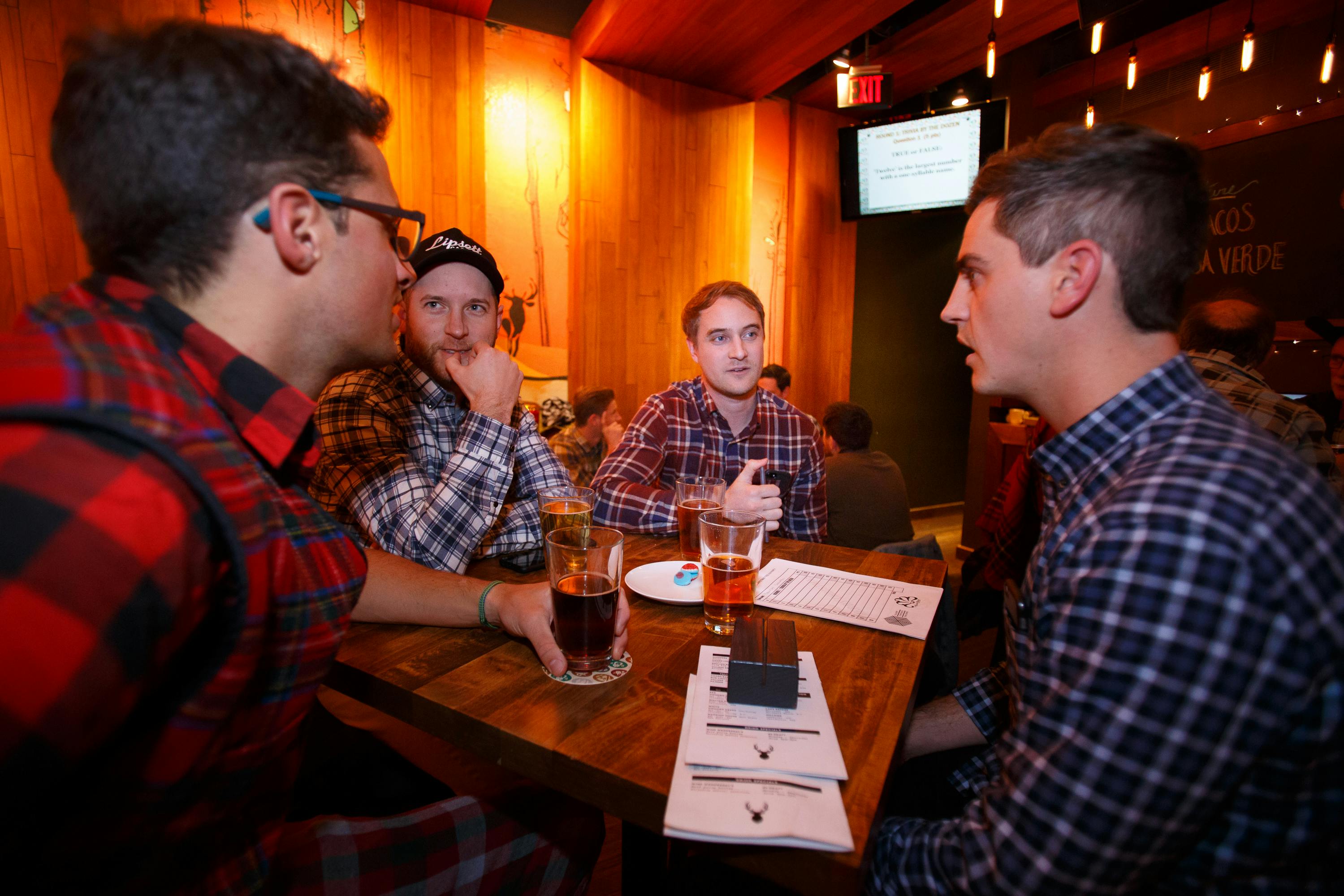 group of 4 people in plaid playing trivia