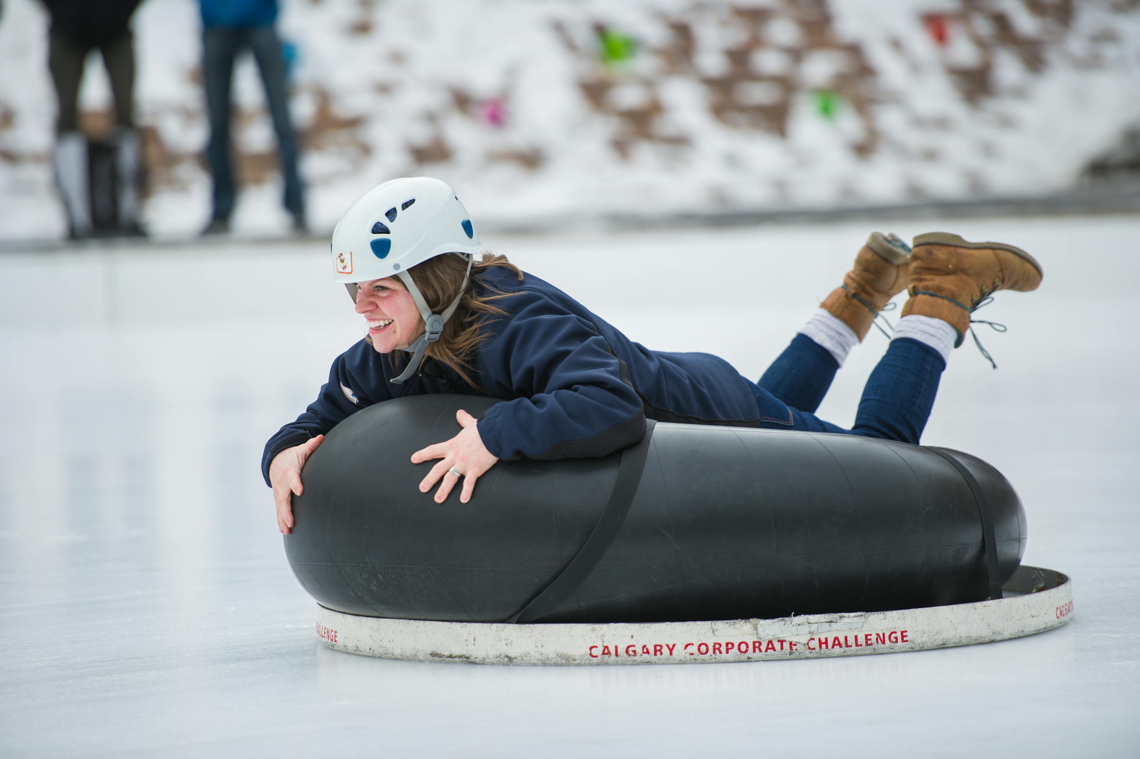 Woman sliding on a rubber tube on ice