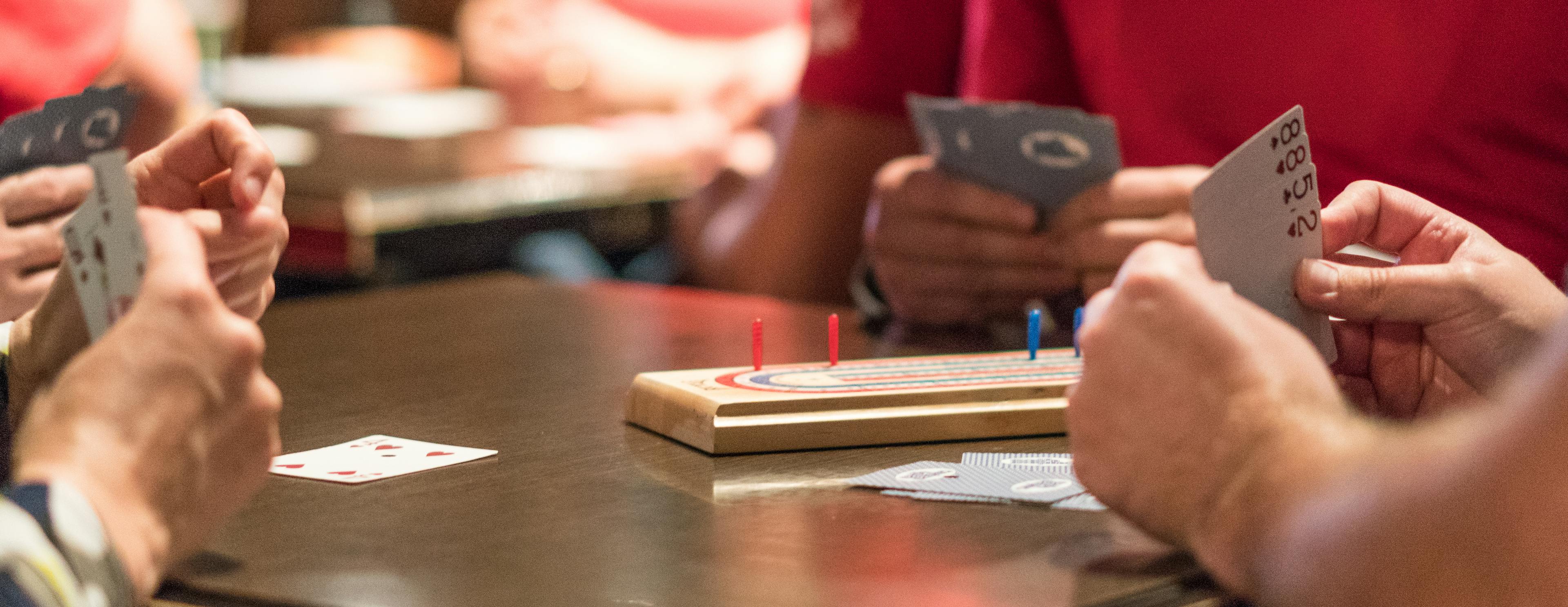 hands of cards playing cribbage