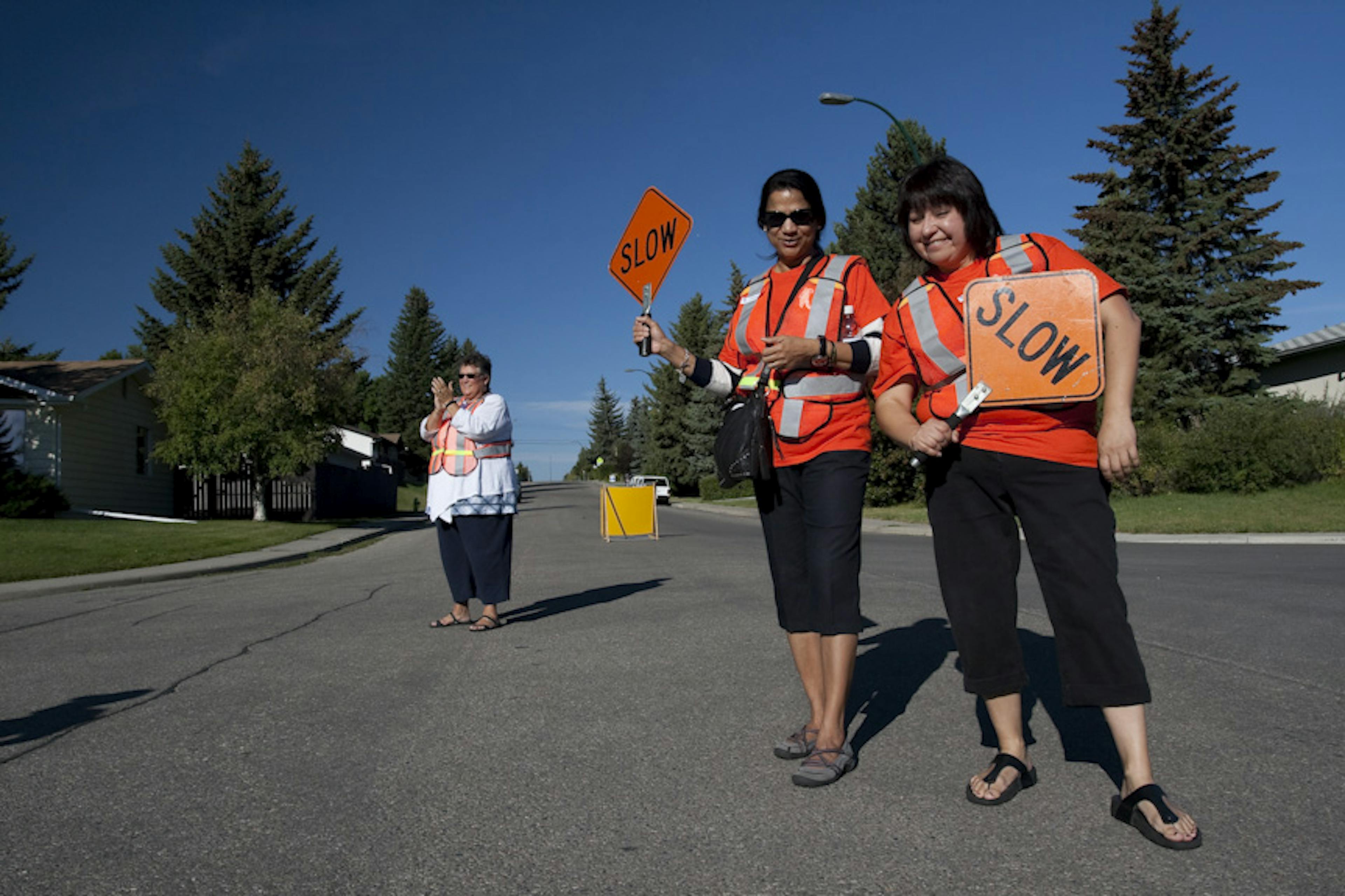  Volunteers holding slow signs at running event