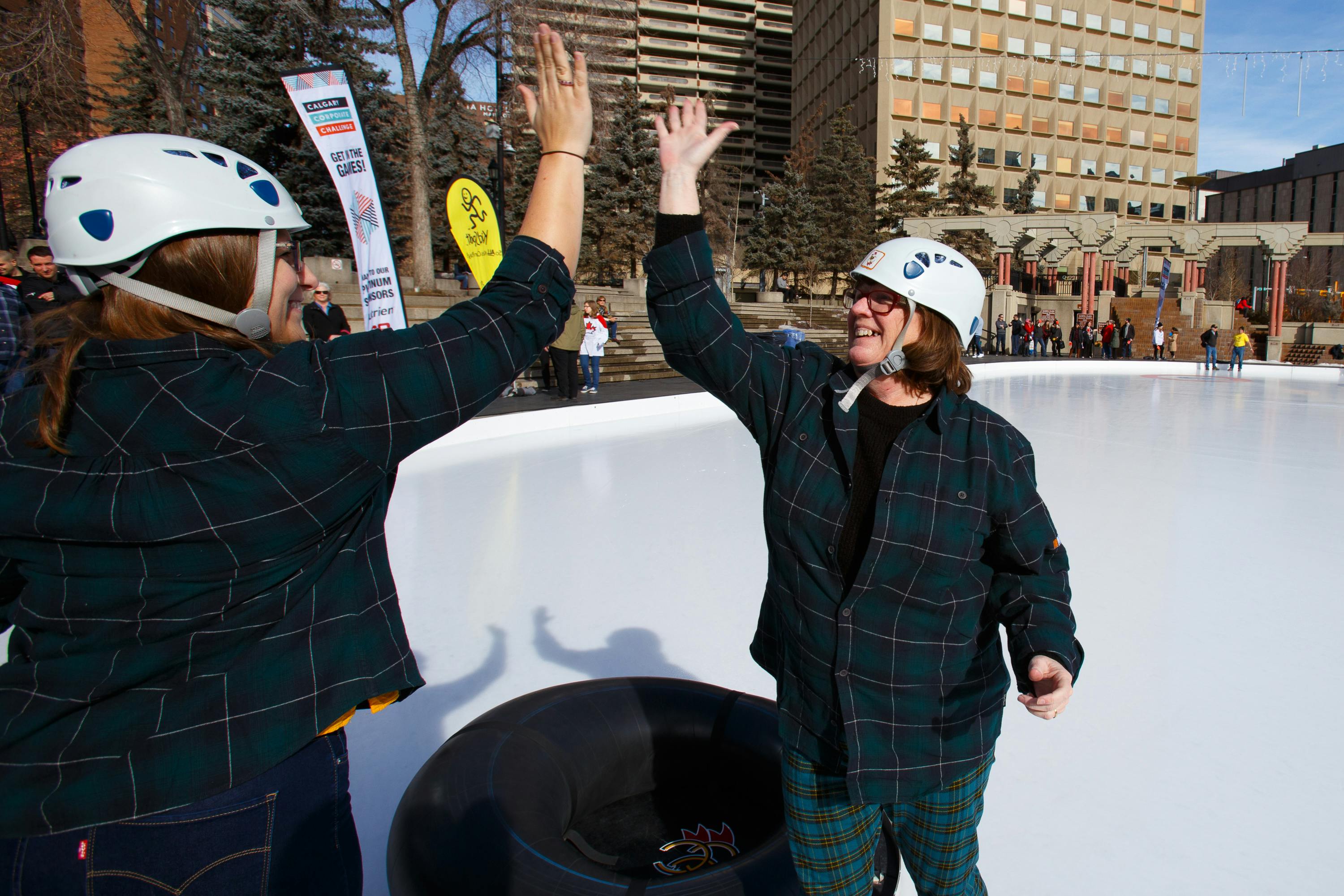 two women high-fiving at Human Bonspiel event