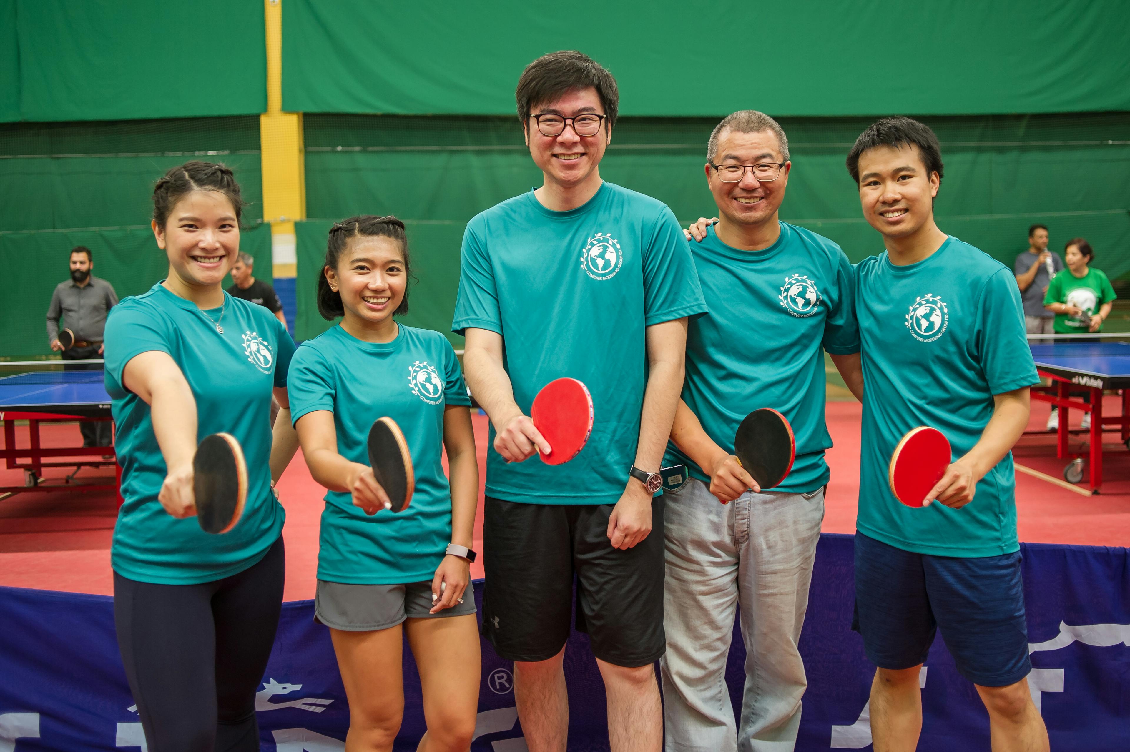team posing at a table tennis tournament