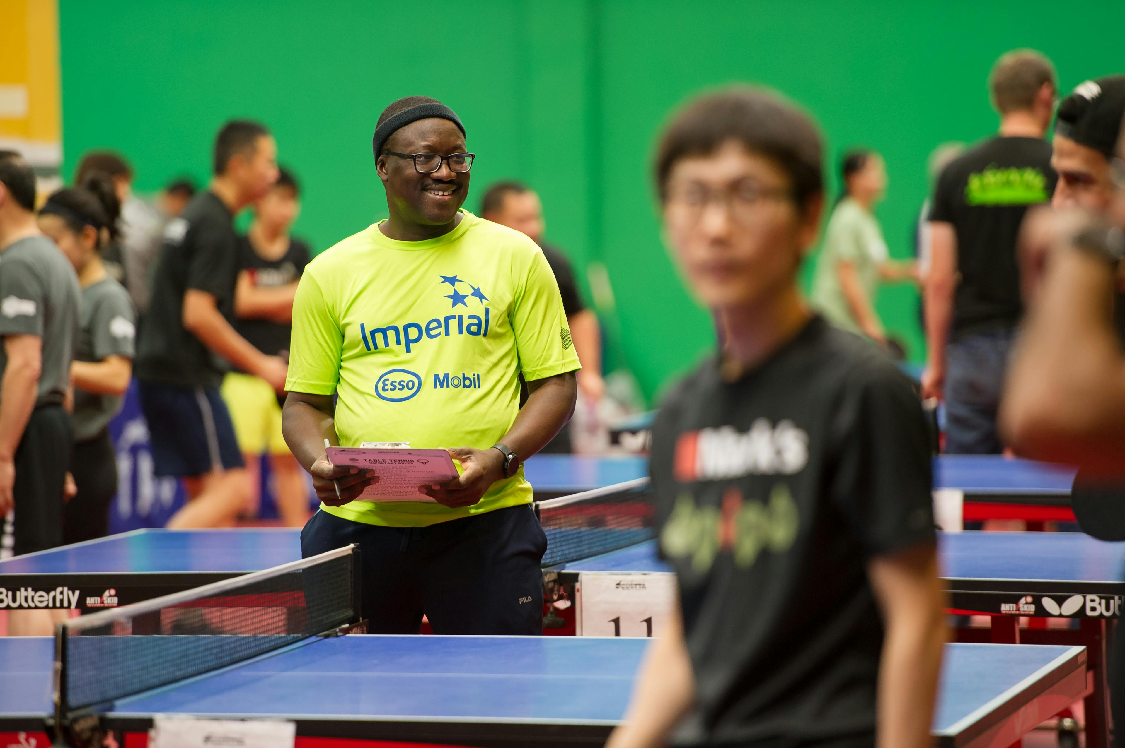 man smiling at a table tennis tournament
