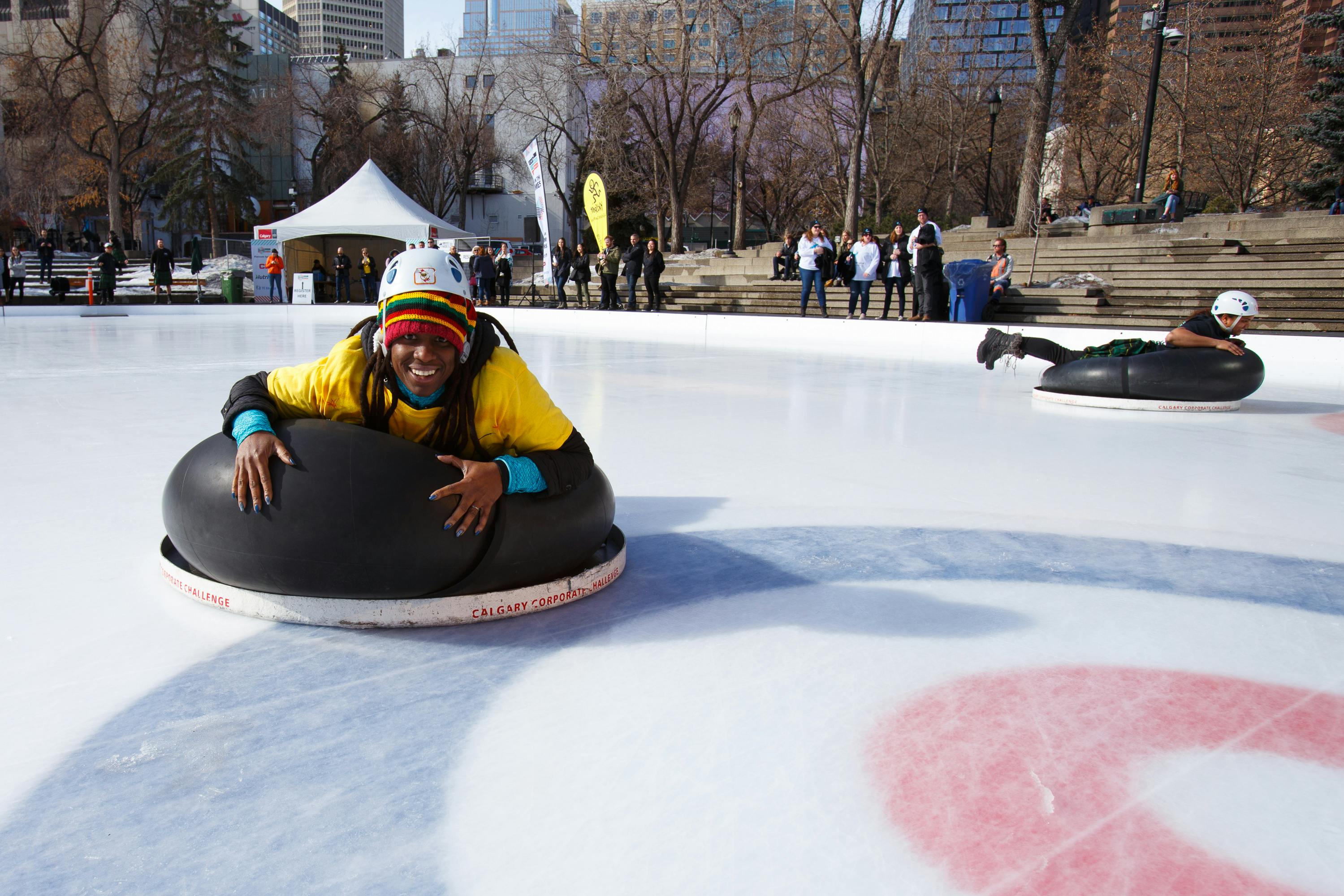 a man smiling on the inner tube next to the curling rings
