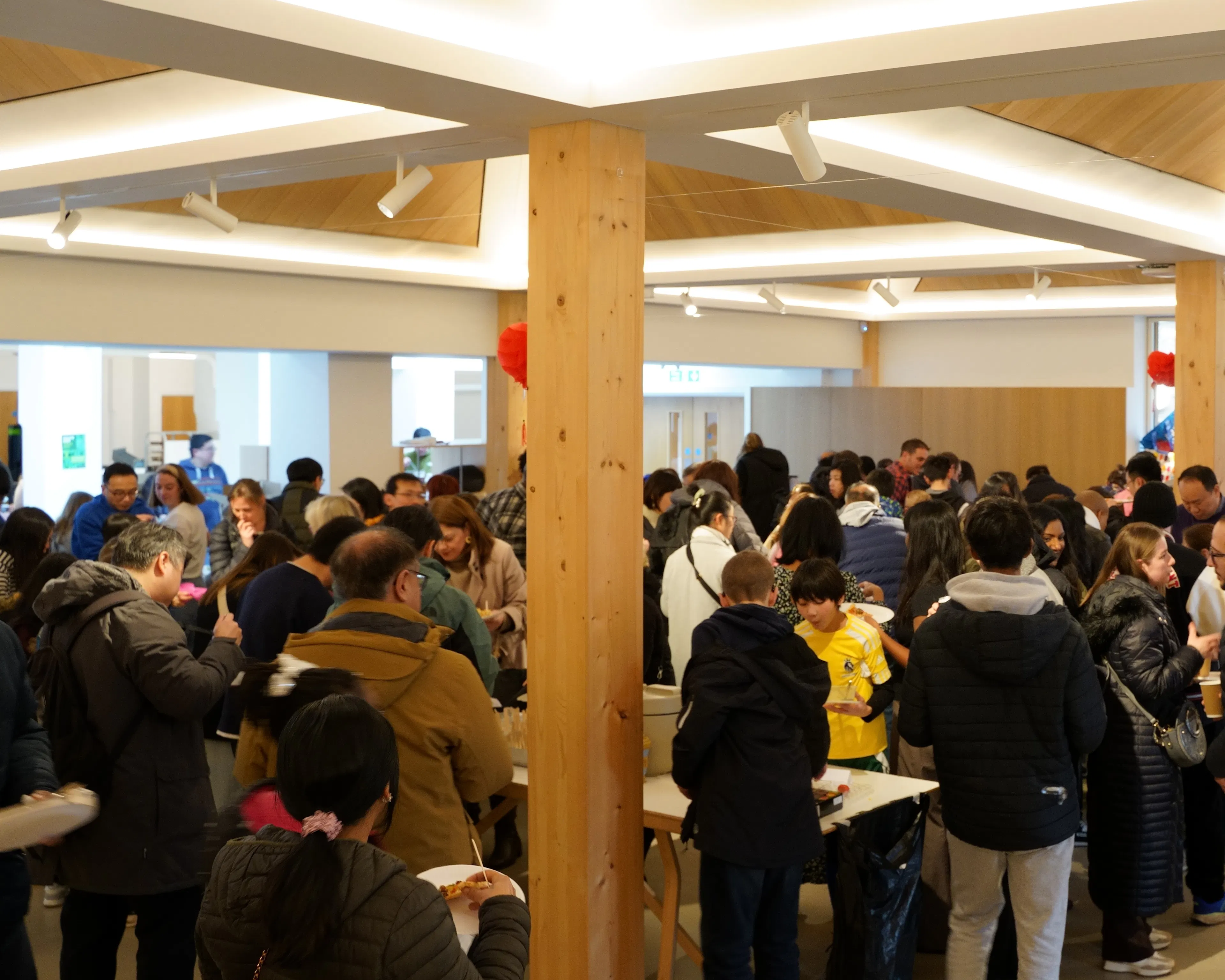 People chatting over refreshments in a bright church hall