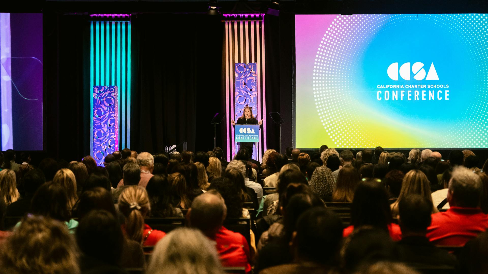 Photo of Cristina de Jesus, CCSA Board Chair President and Chief Executive Officer at Green Dot Public Schools California speaking to a room full of charter school leaders at conference.