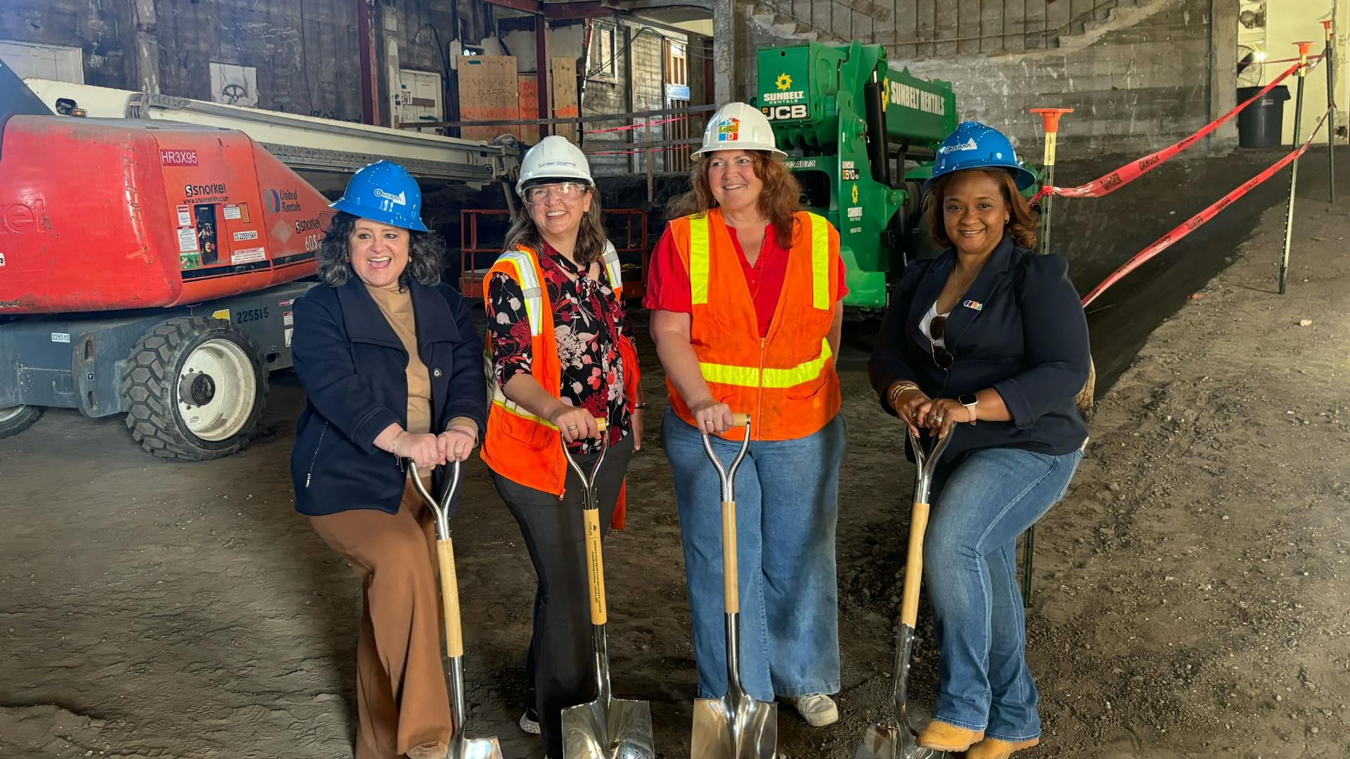 Photo of two CCSA staff and two charter leaders breaking ground at a new facility.