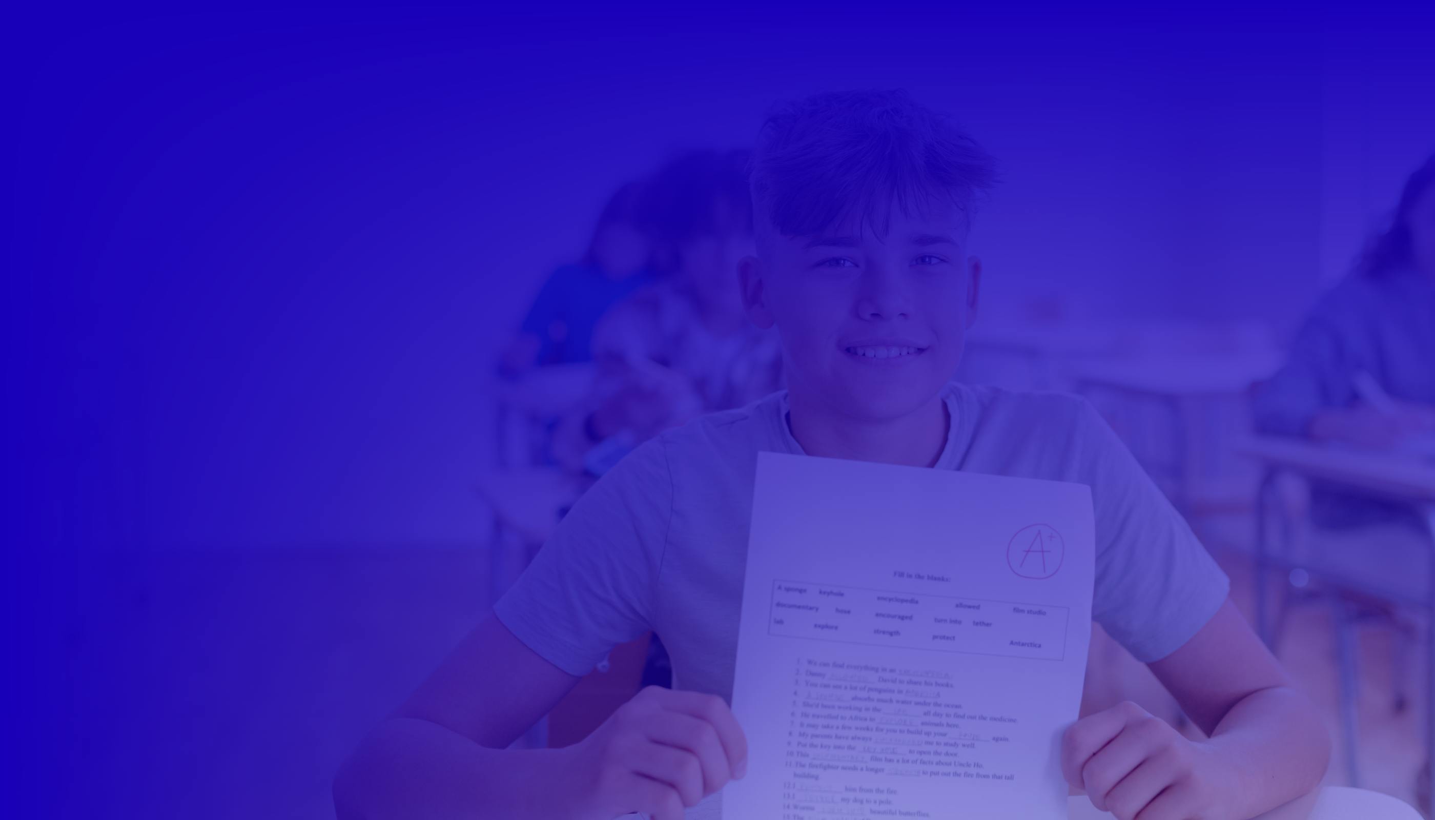 Student holding up an paper with an A+ grade. 