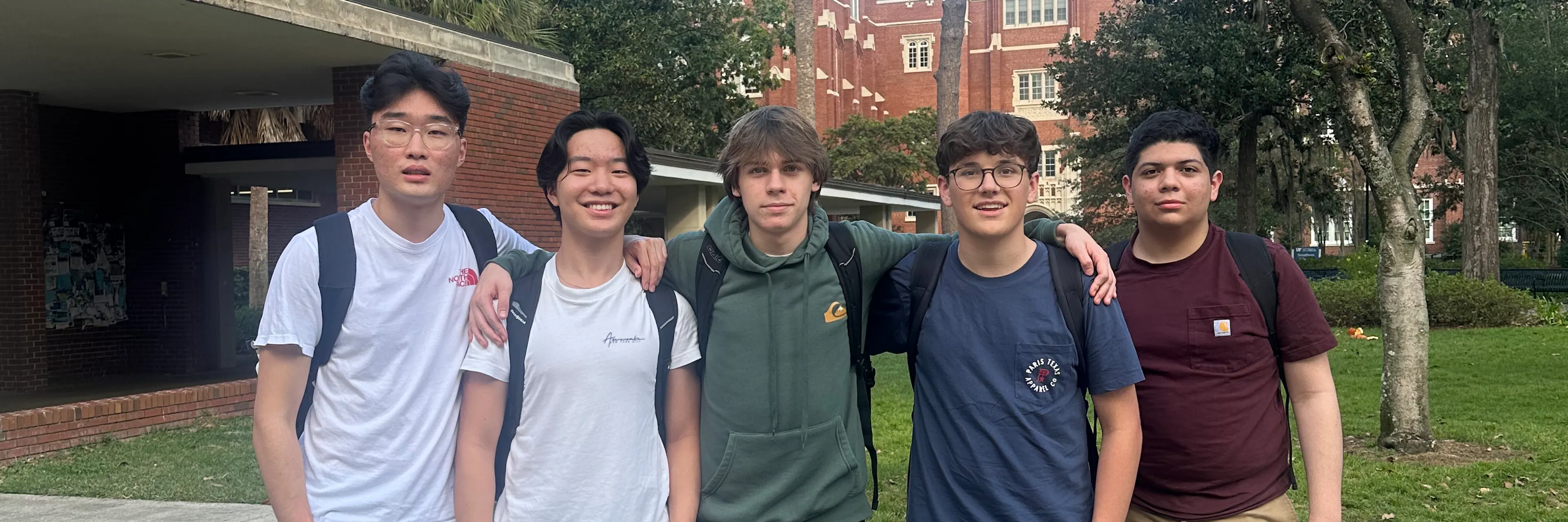 5 students pose for a photo outside