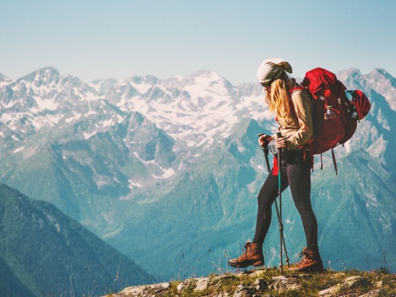 A travler hiking with mountains in background