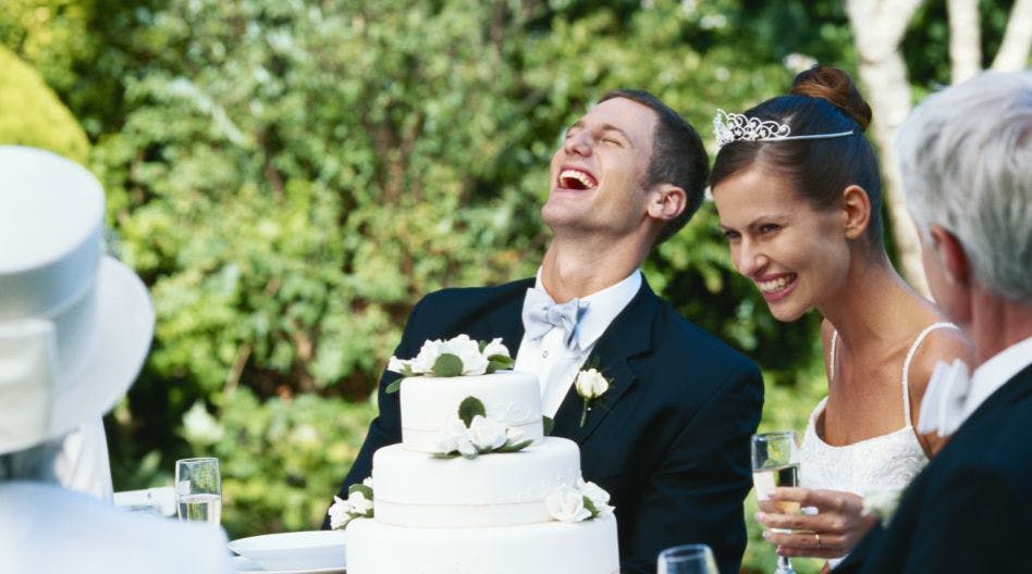 wedding couple laughing during toast