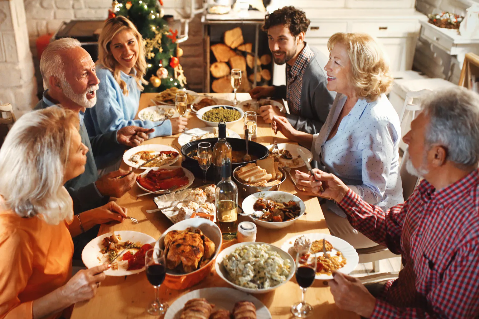 Family enjoying a warm Thanksgiving meal together around the table.