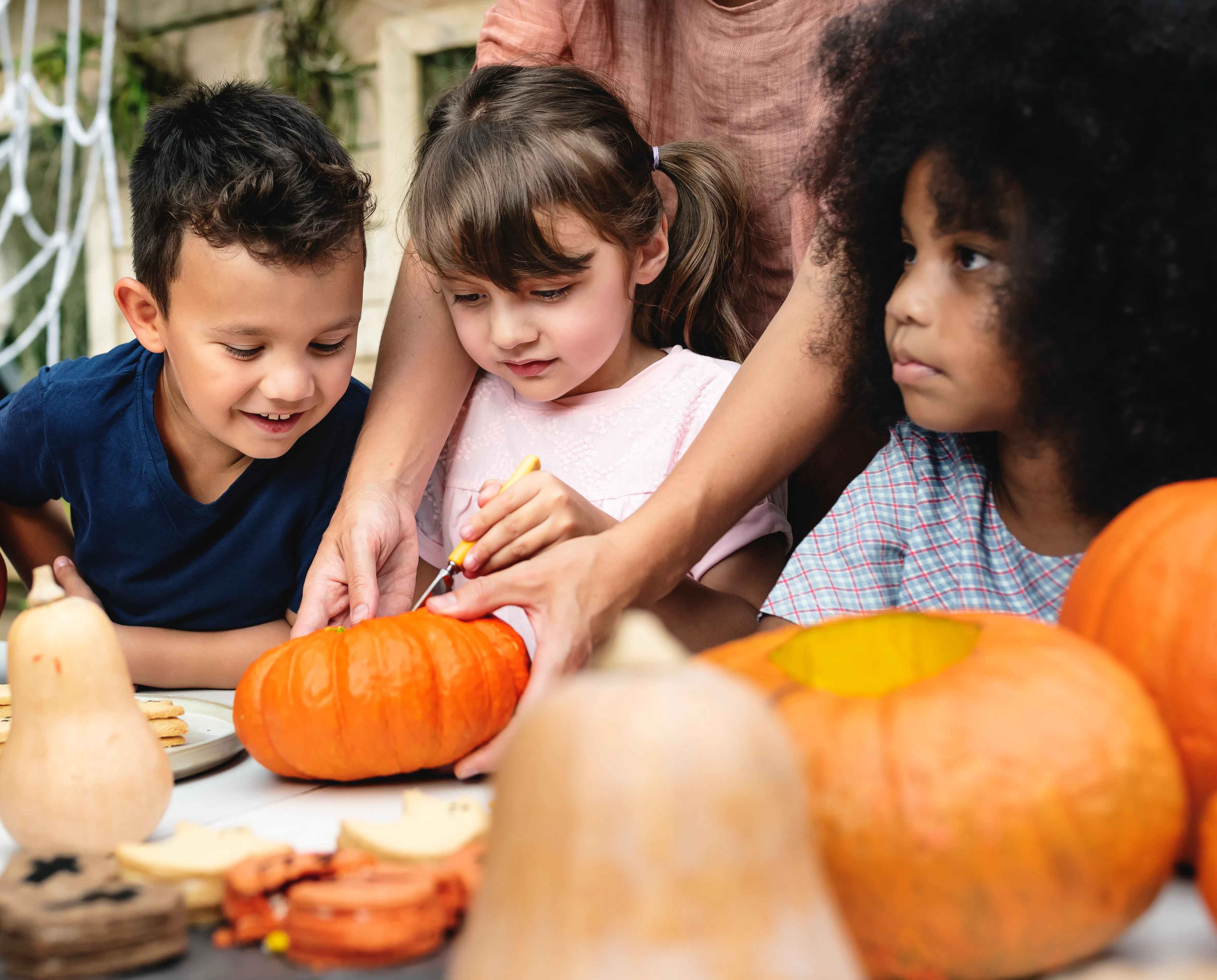 Children carving a pumpkin