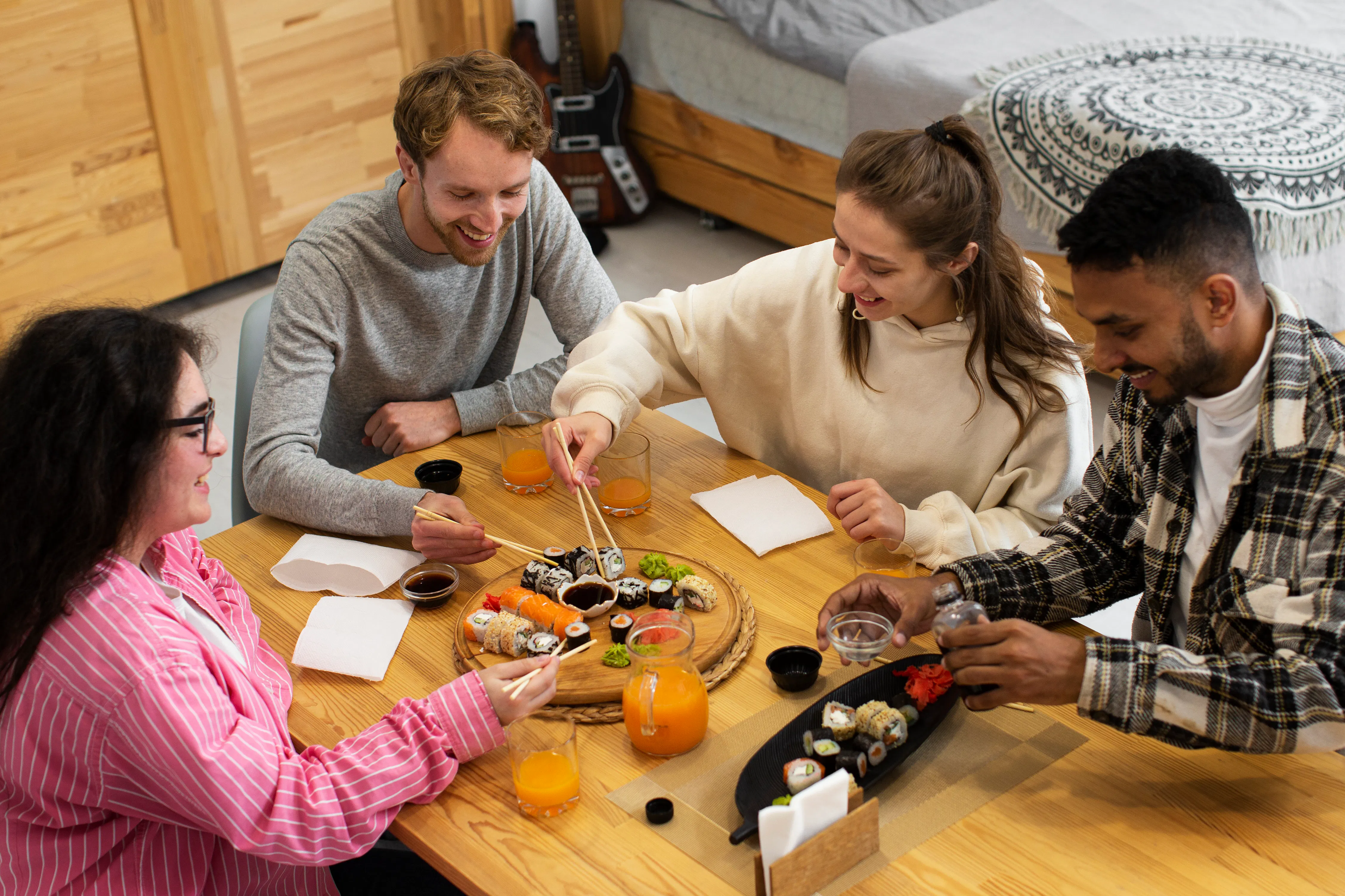 Friends sharing sushi around a cozy dining table.