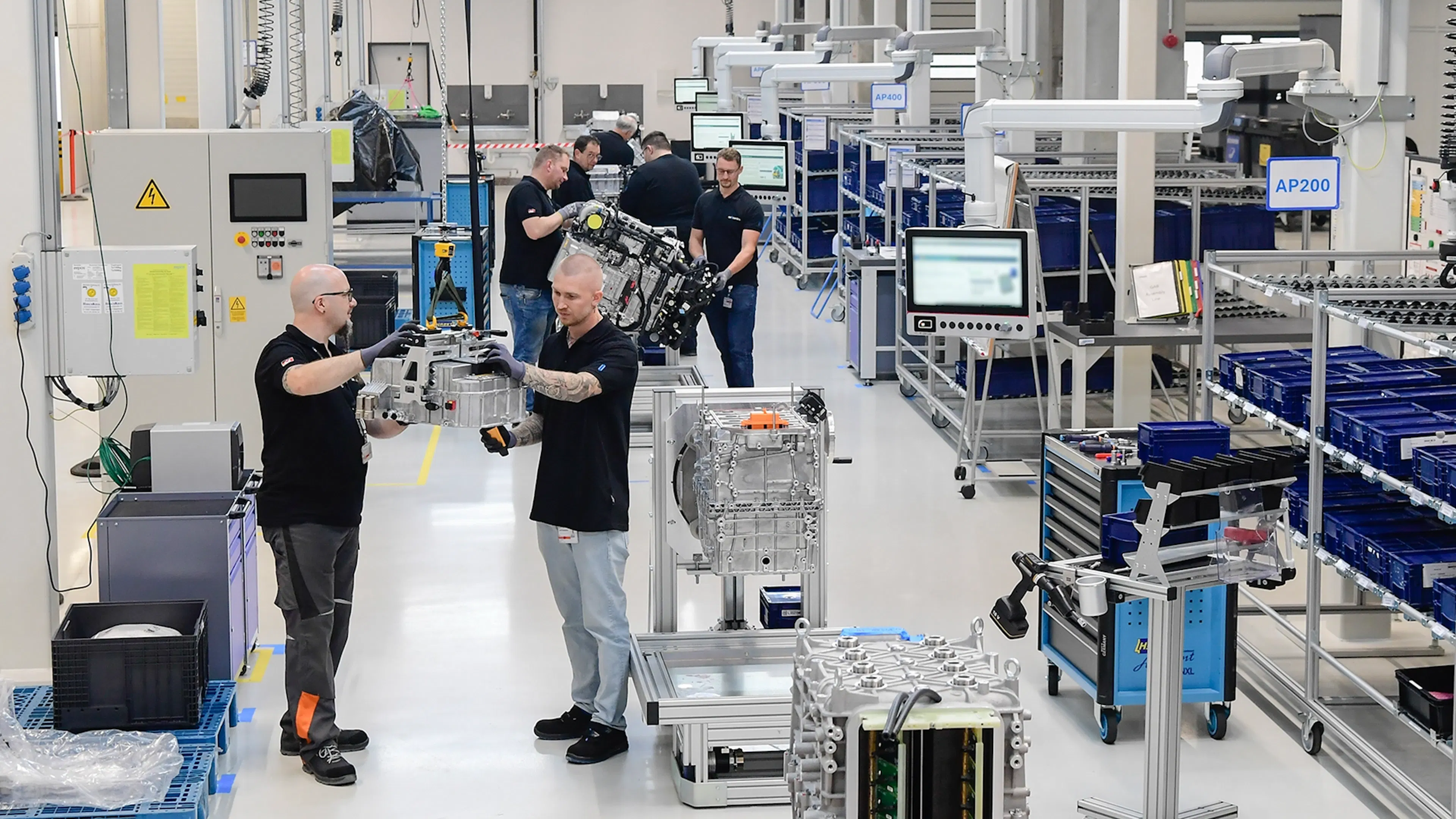 Technicians assembling fuel cell components in a modern production facility