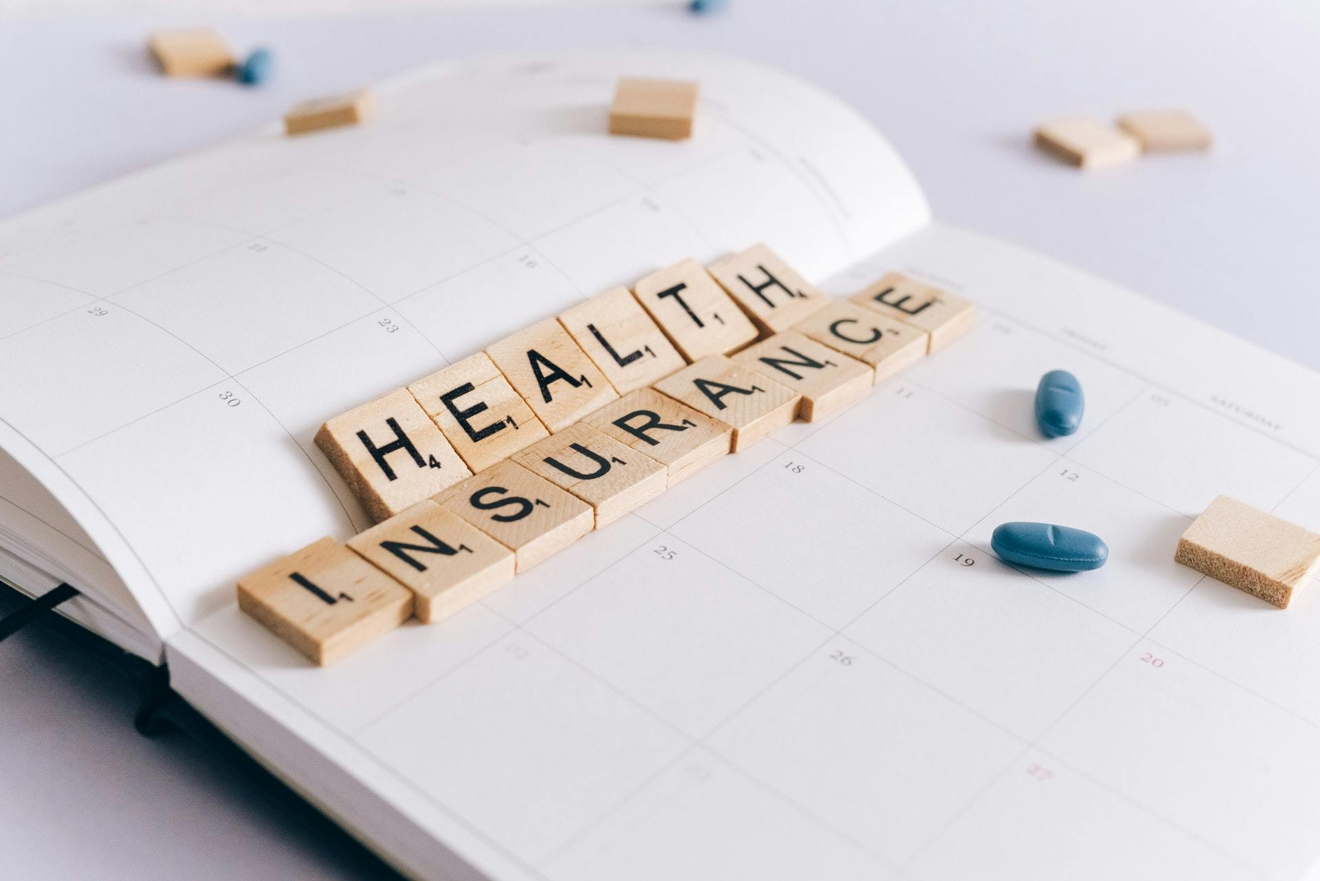 Health insurance written in Scrabble tiles