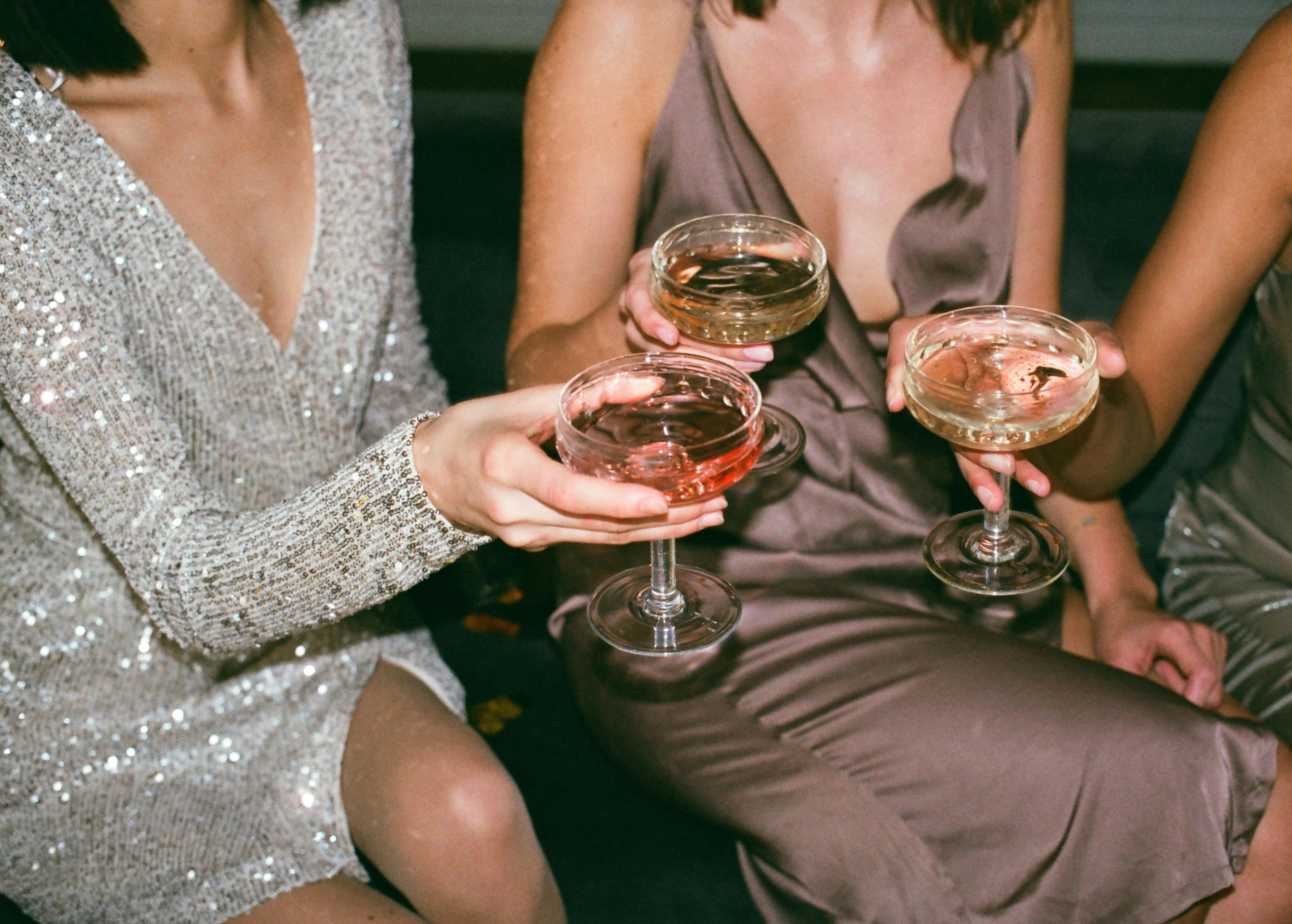 Three women drinking cocktails