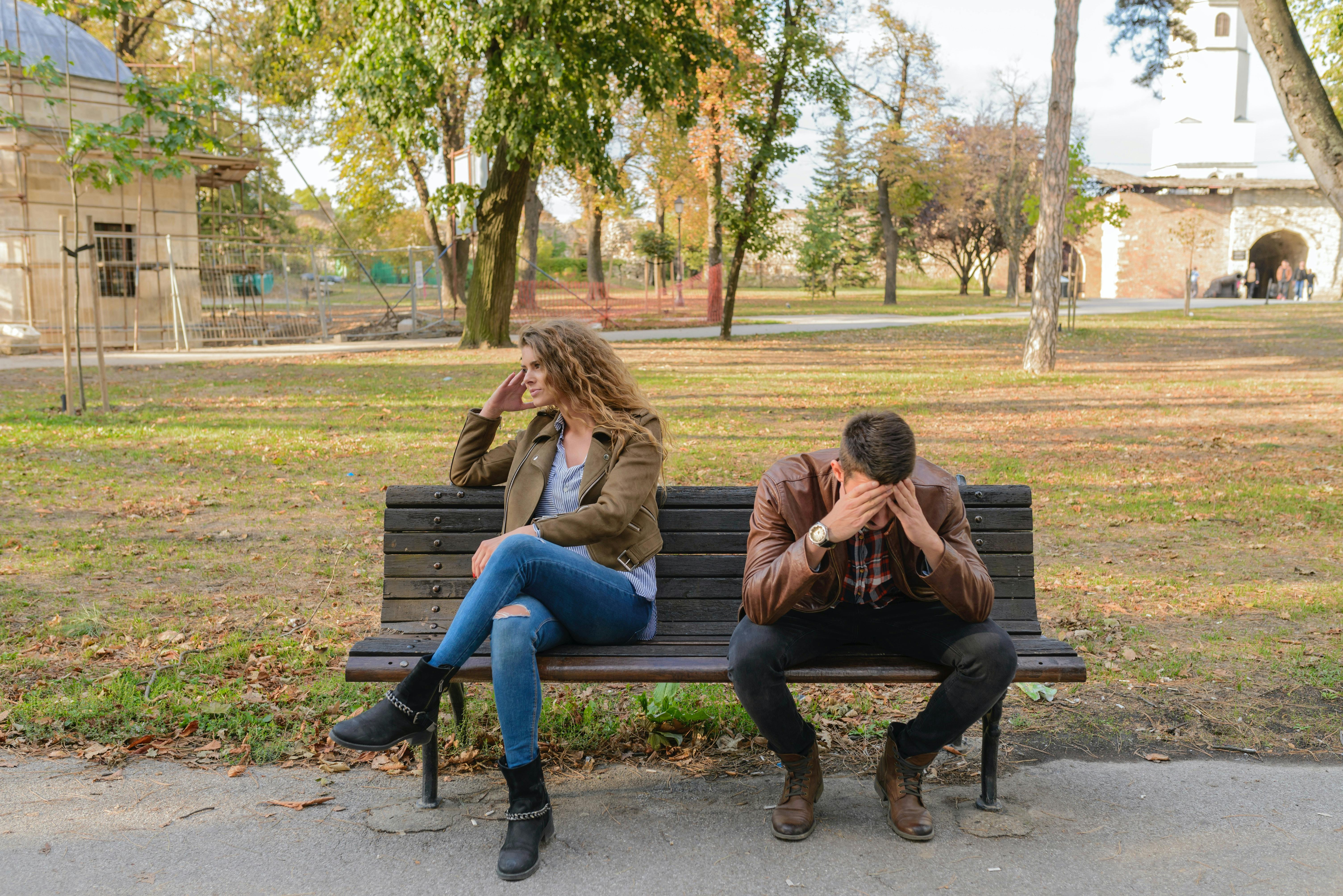 Couple in distress on a park bench