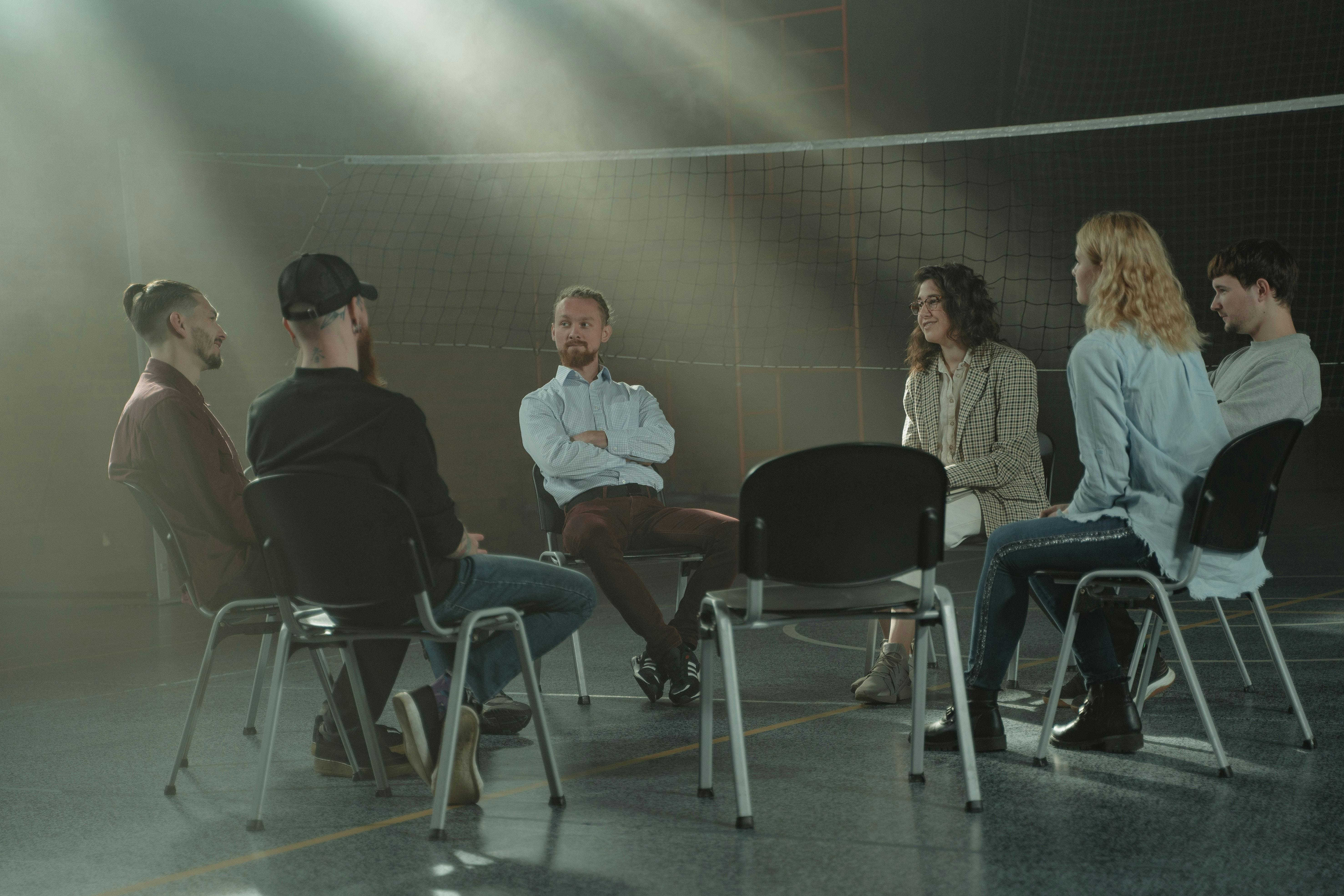 group of people talking in peer support group