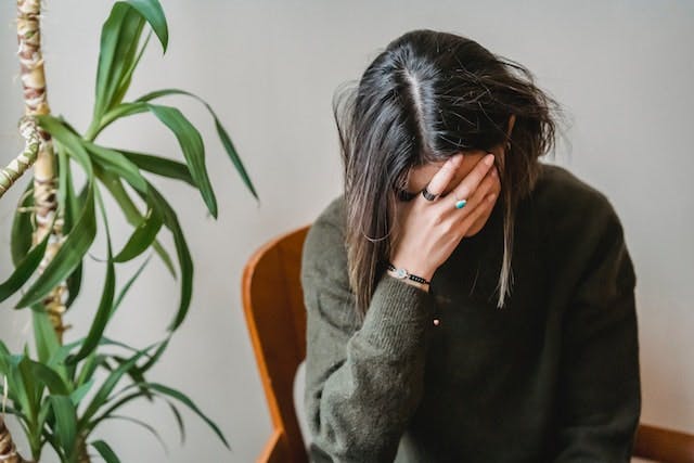 anxious woman covering face