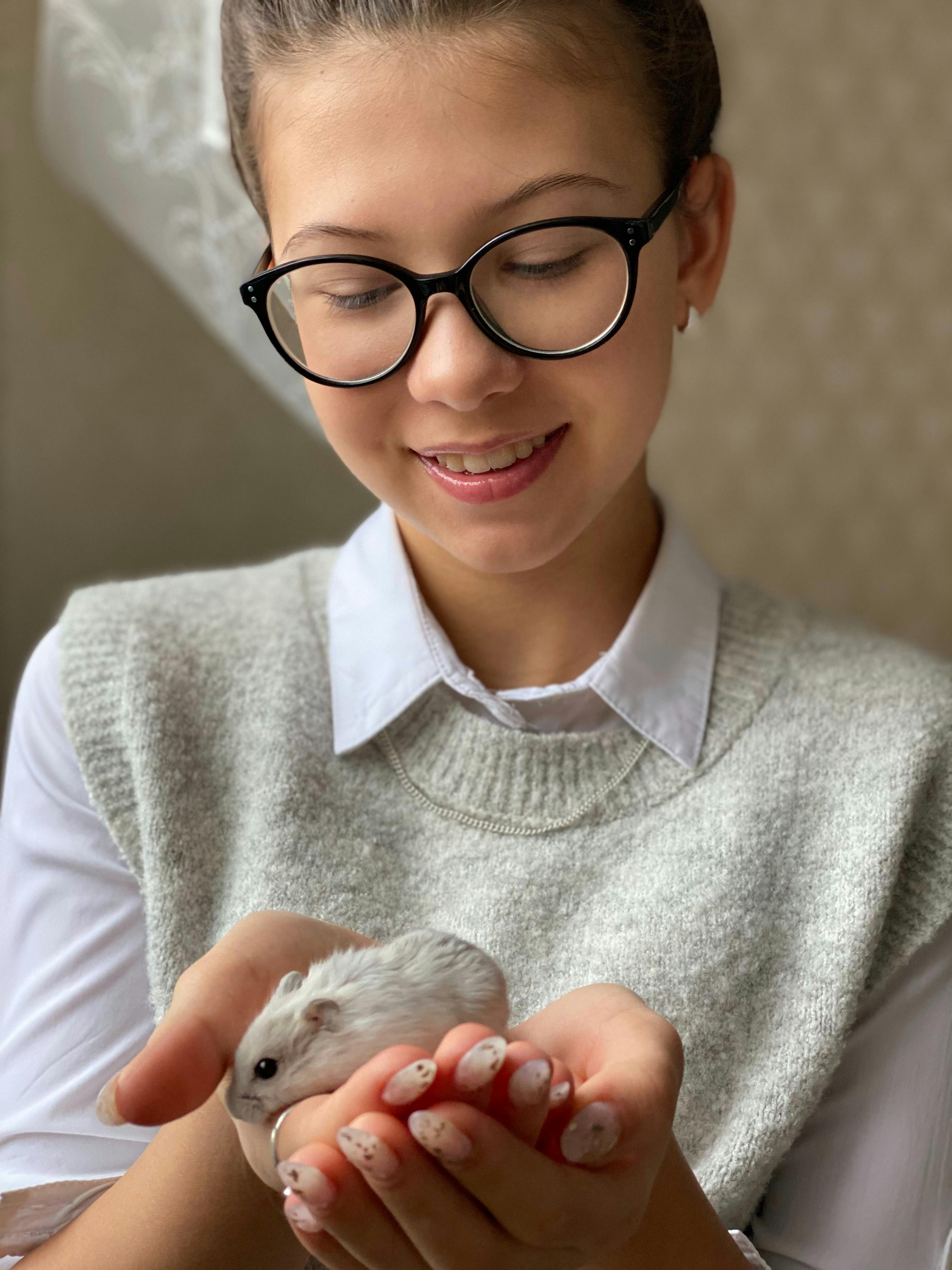 woman holding gerbil in hands