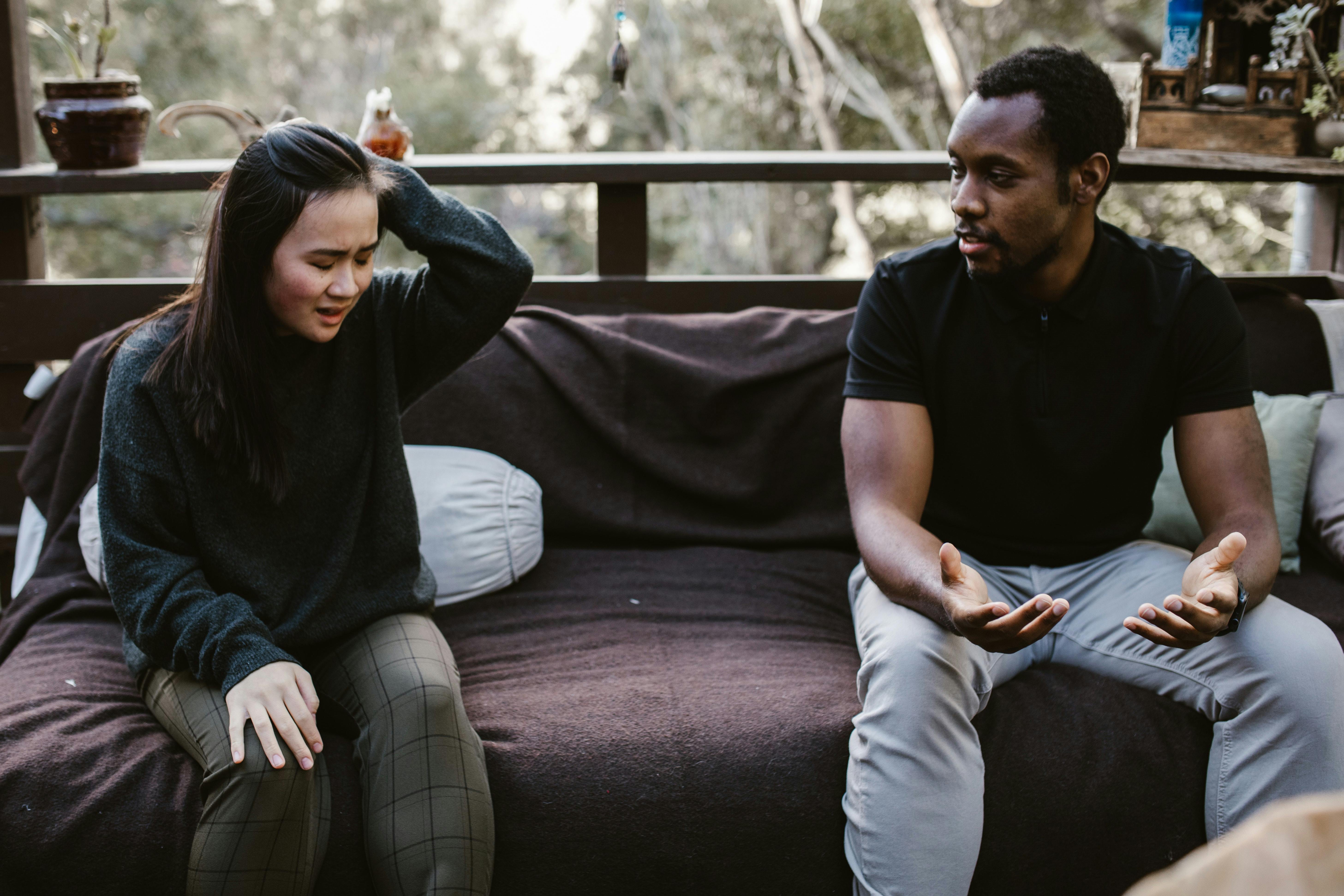 Man and woman sitting and having a difficult conversation