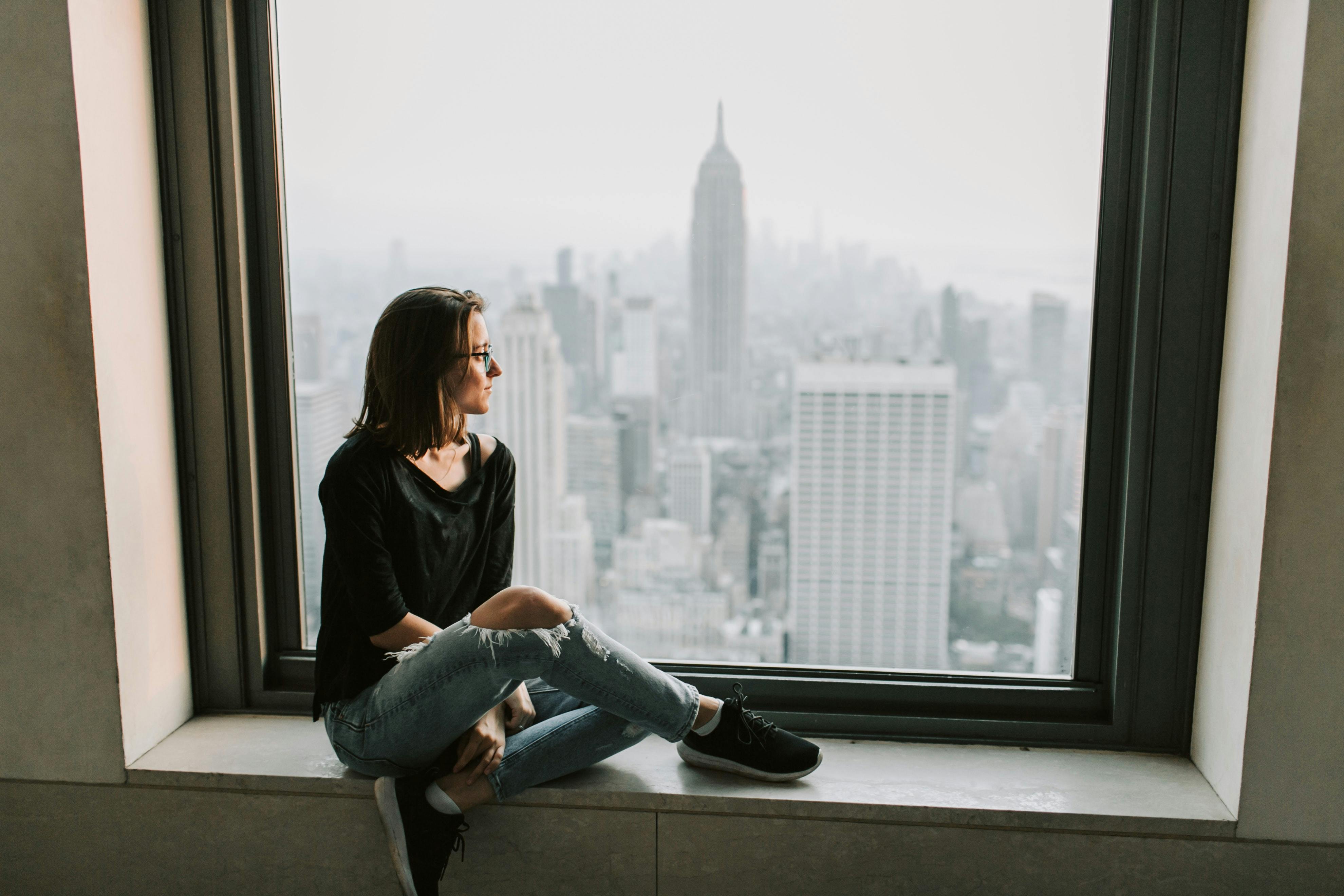 Women looking out the window at New York from above