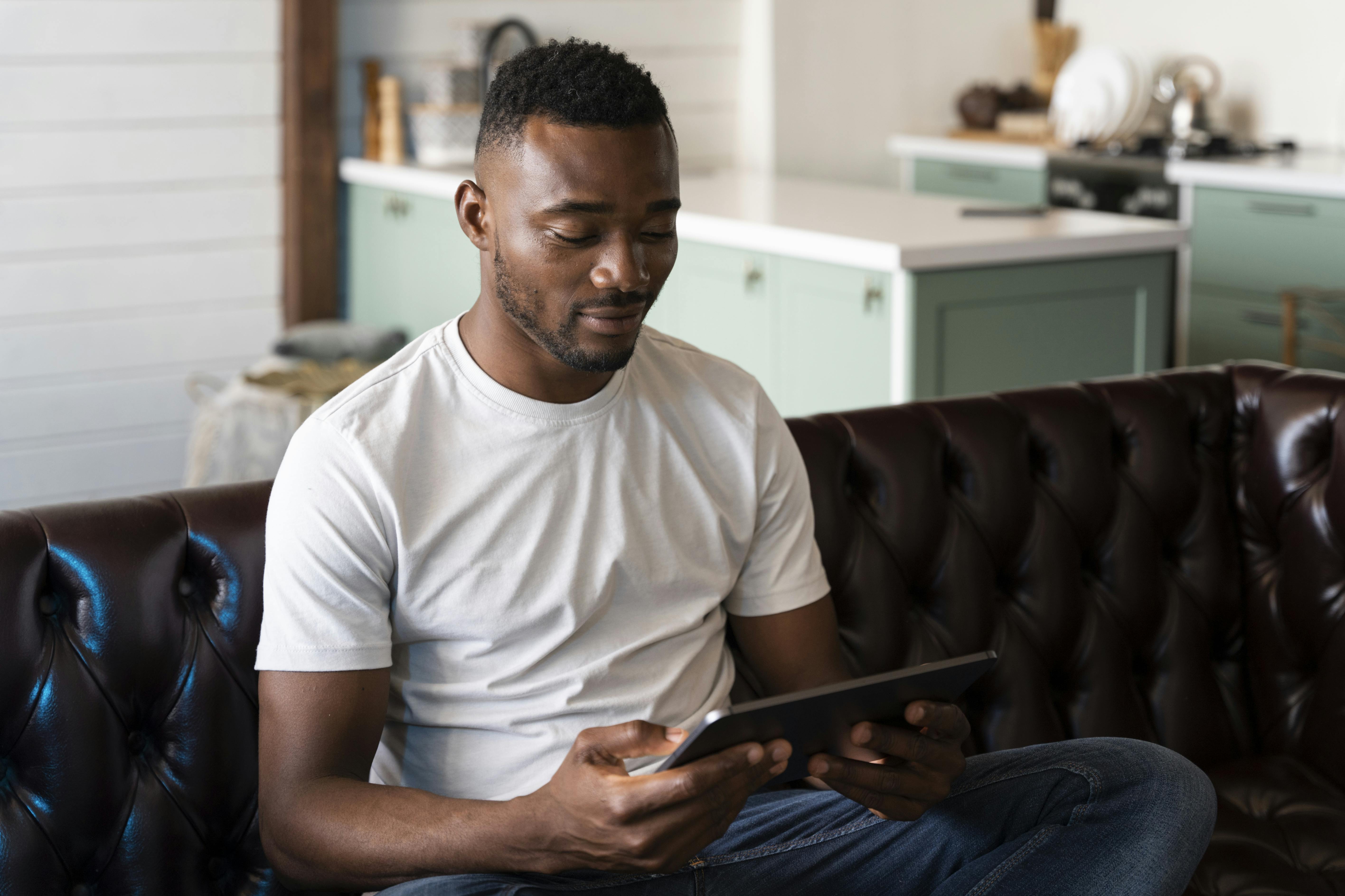 Black man takes an online assessment on a tablet 