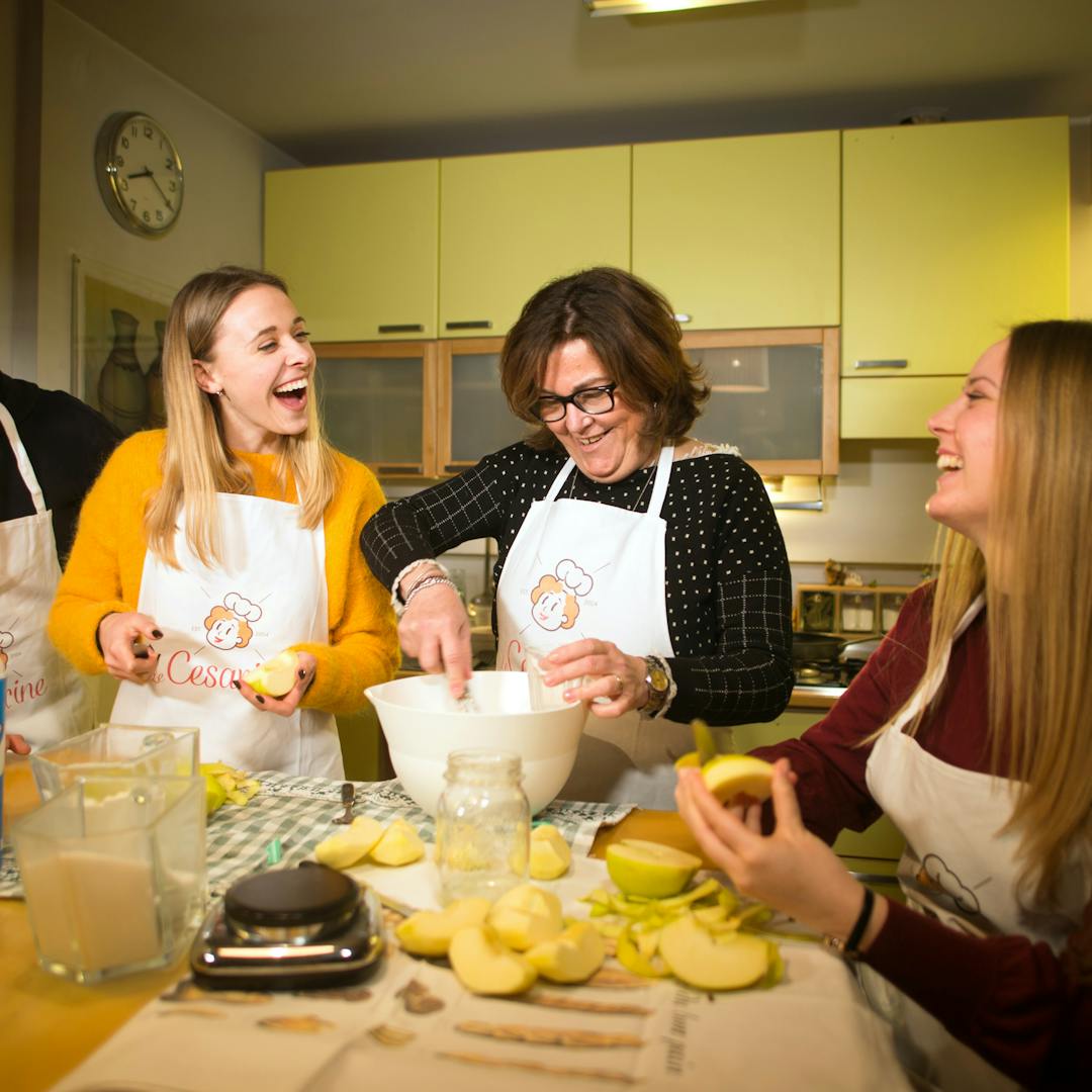 People laughing in a cooking class in Milan