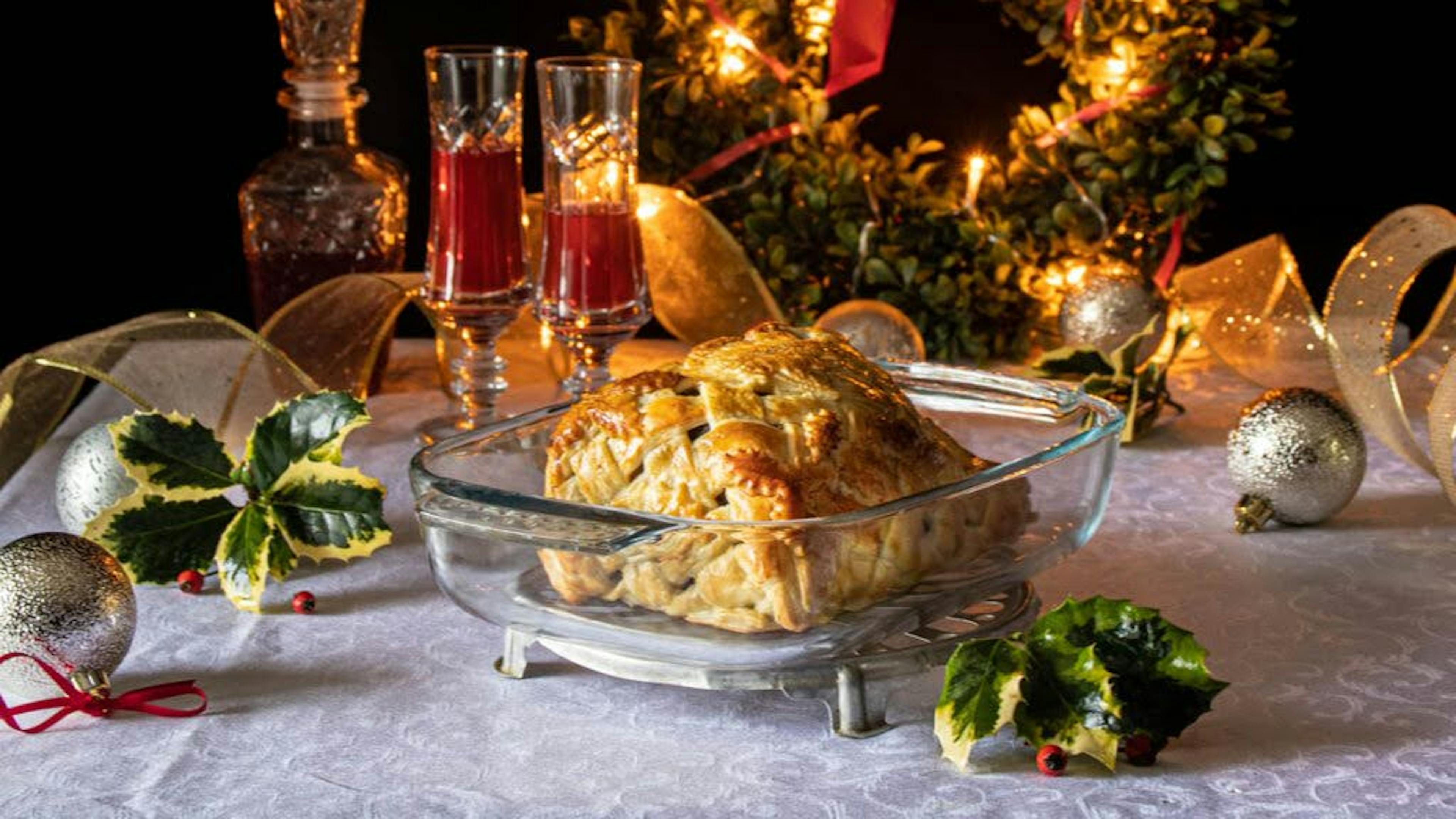 roast in pastry on a table, christmas decoration in the background