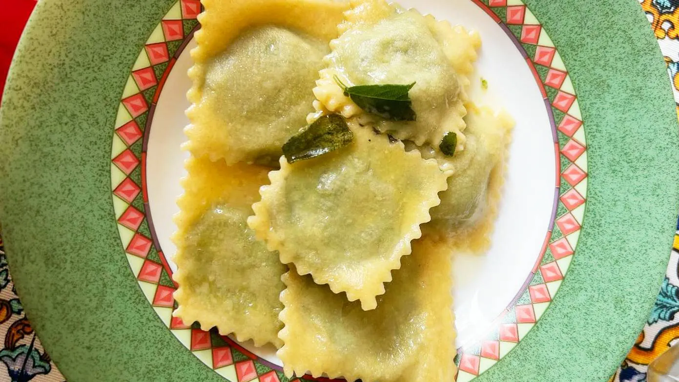 Ricotta and spinach ravioli by Cesarino Maurizio, seasoned with butter, sage, and Parmesan.