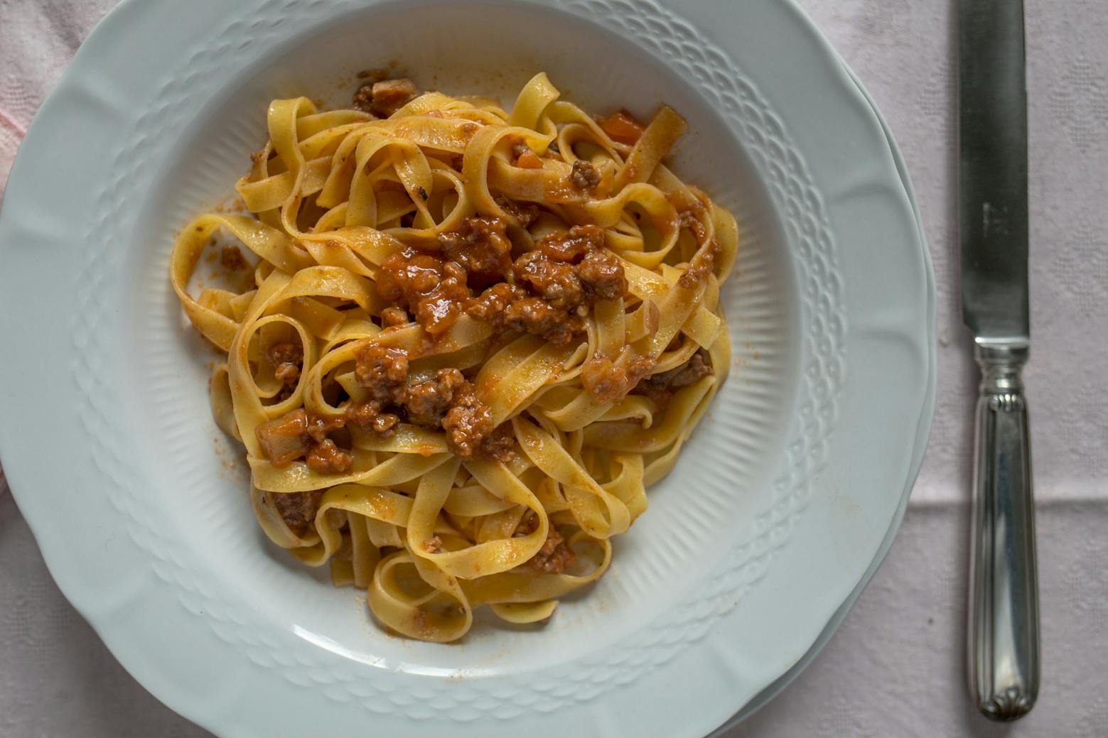 Plate with tagliatelle with ragout sauce
