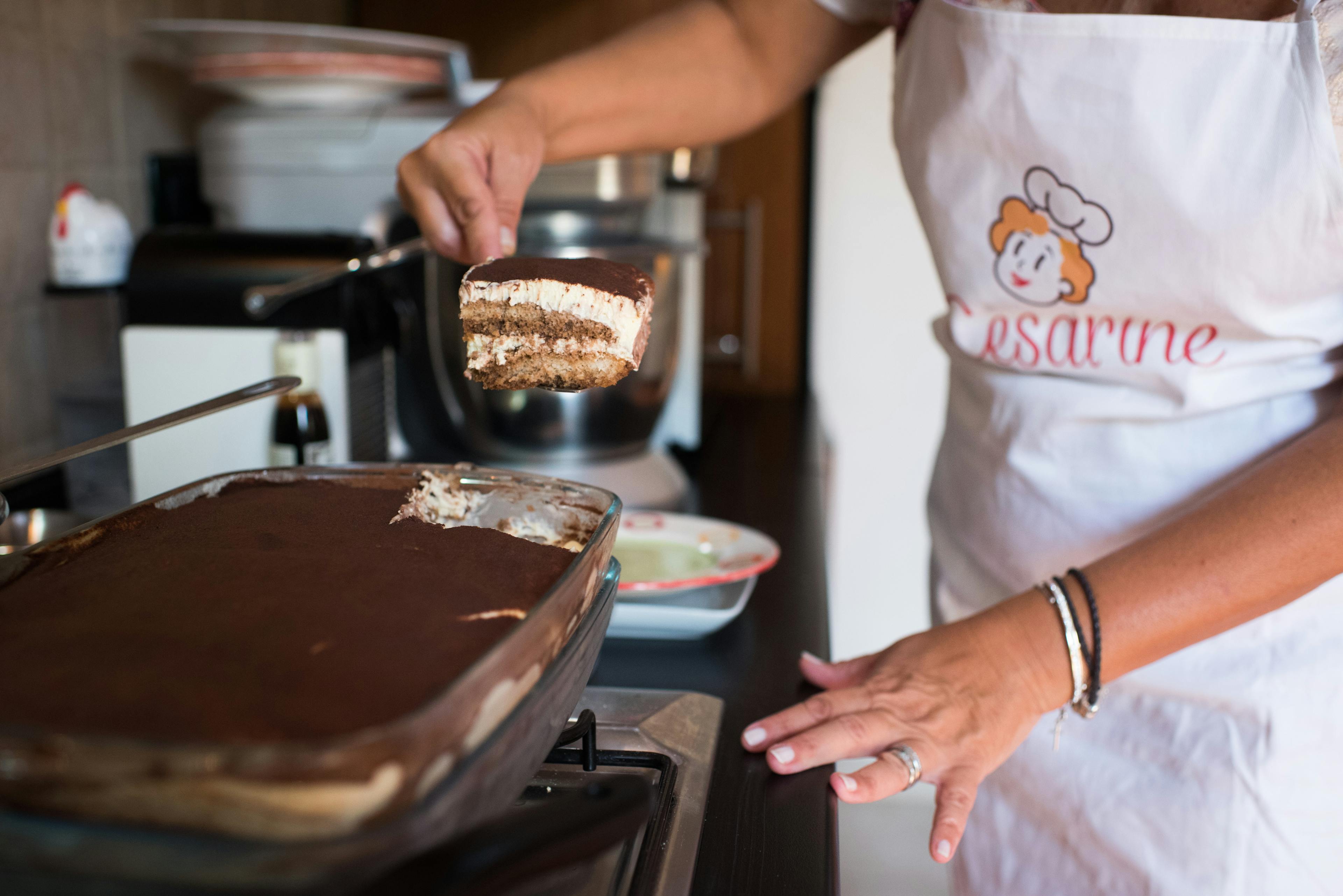 Cesarina shows a slice of tiramisù