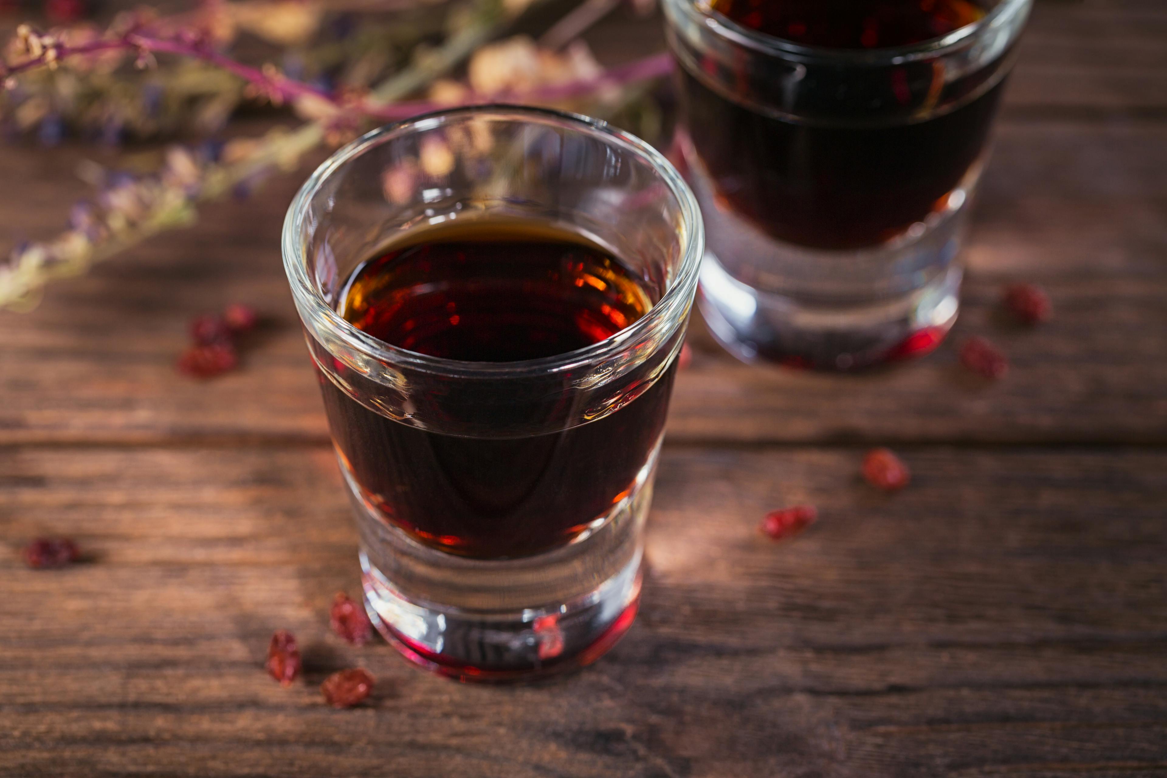 A shot glass of liqueur on a table