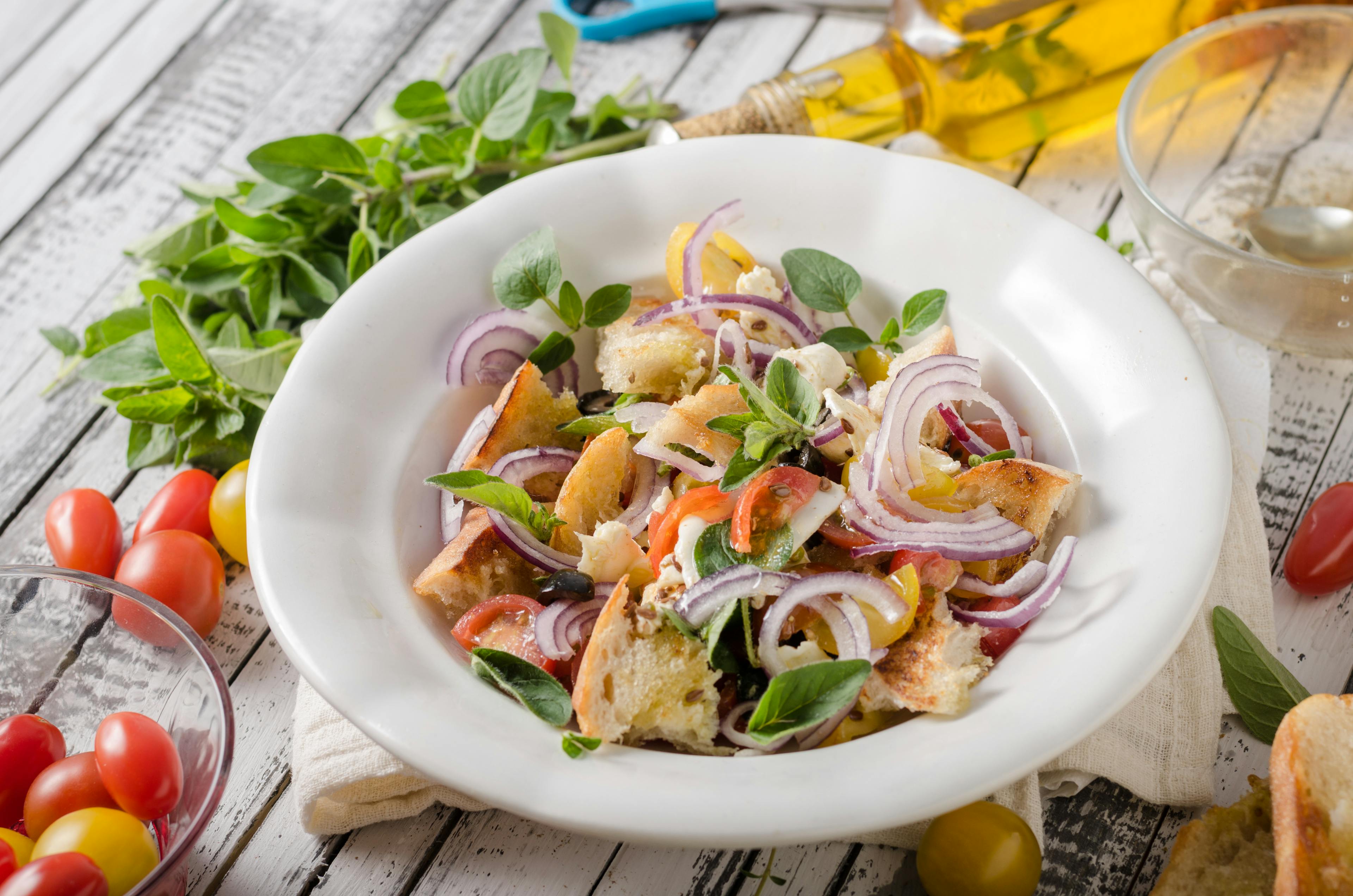 A dish of panzanella on a set table