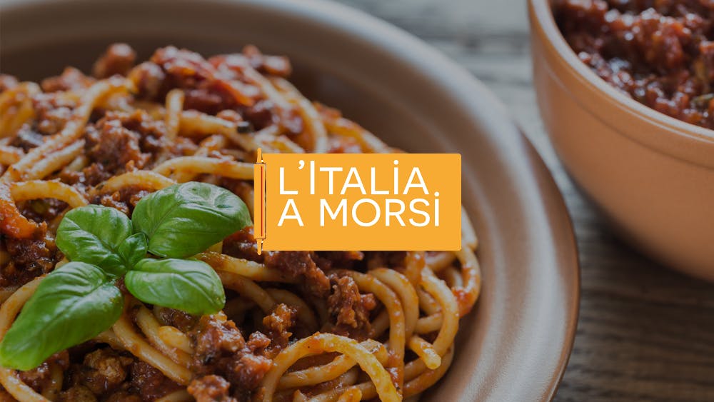 Italia a Morsi logo in the background of a plate of spaghetti