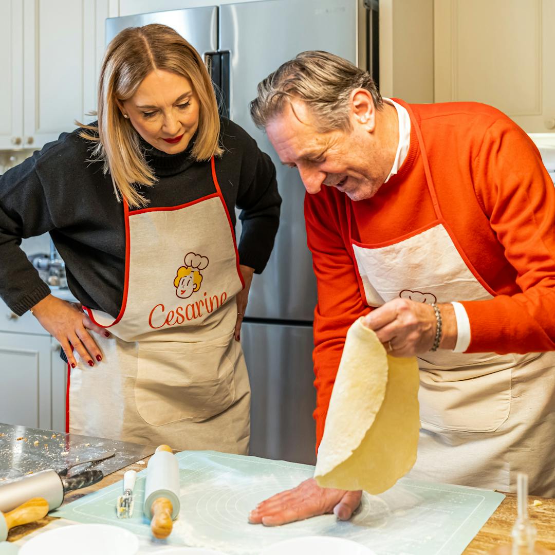 Woman and man making dough during a cooking class