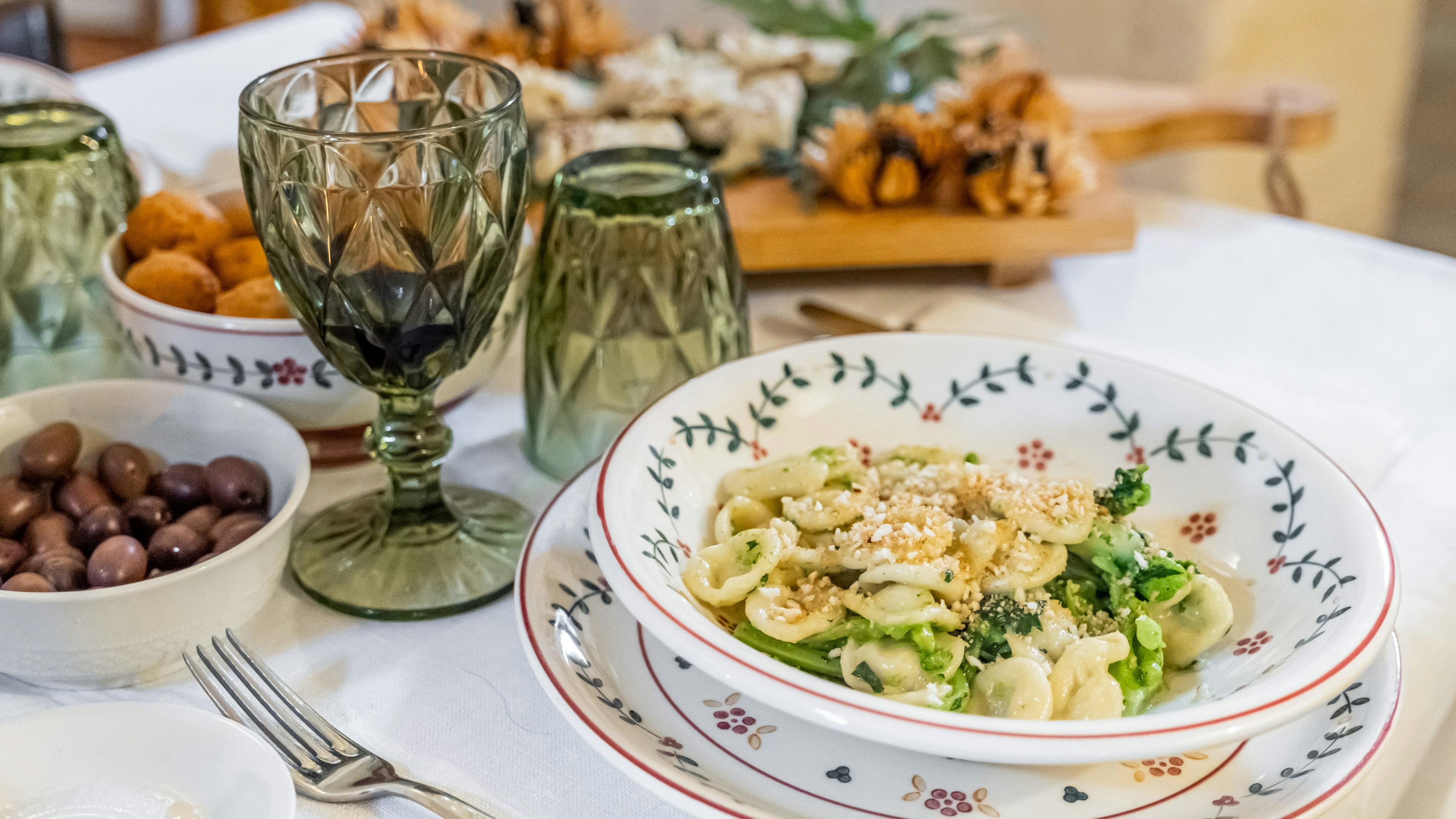 Plate of orecchiette with turnip tops on a set table