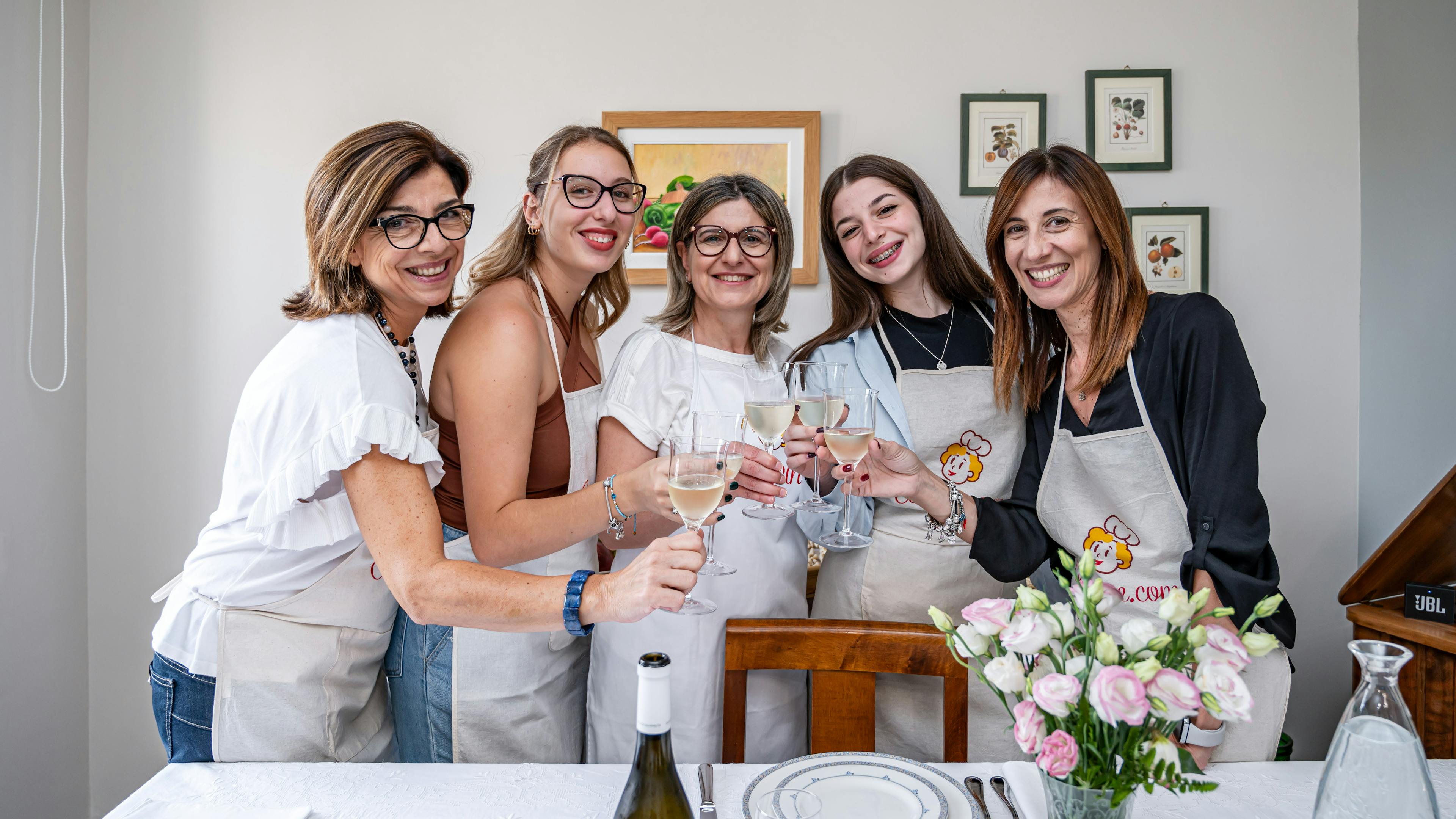 Group of women toasting in front of a table