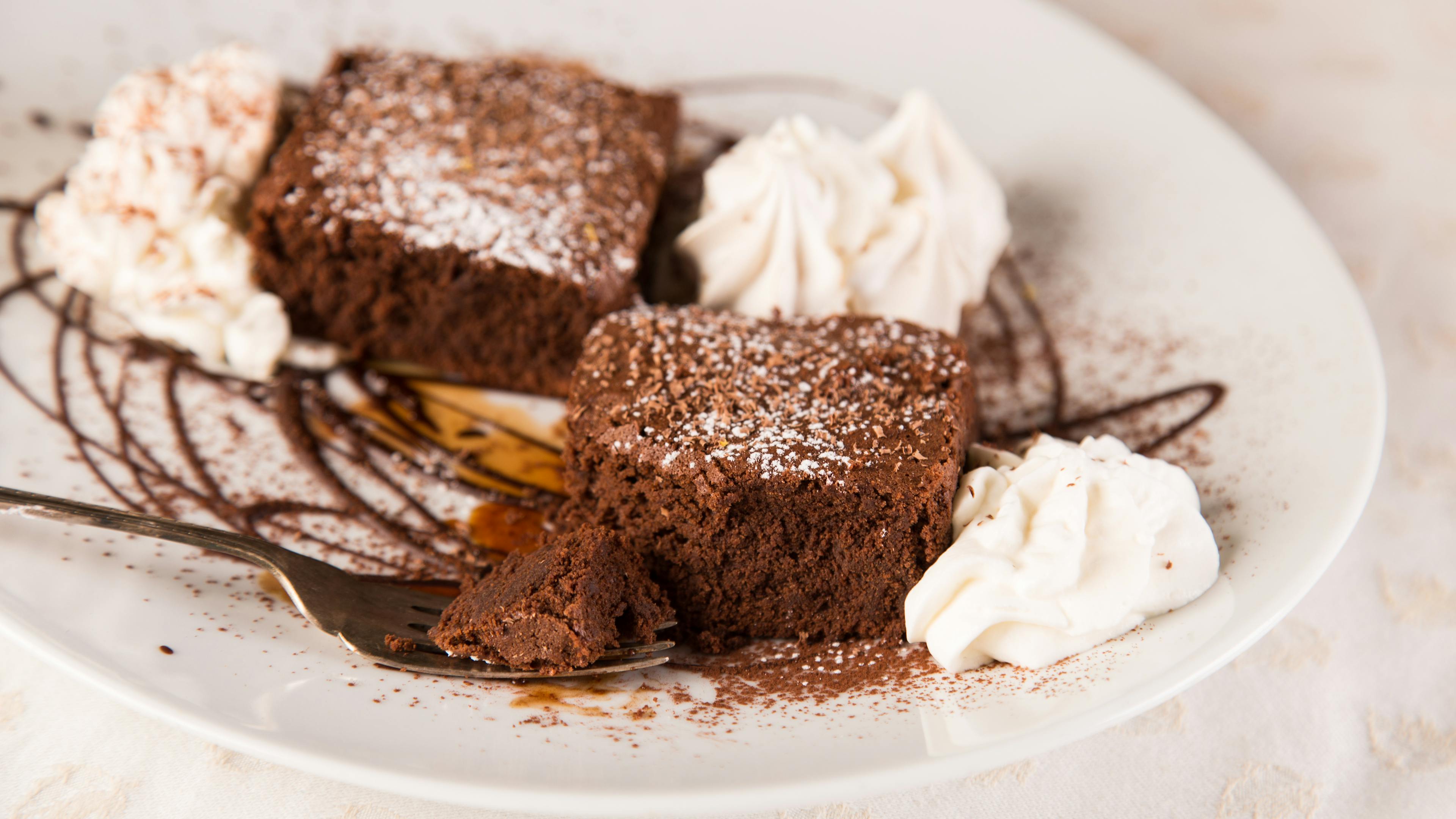 Plate with Tenerina cake served with whipped cream