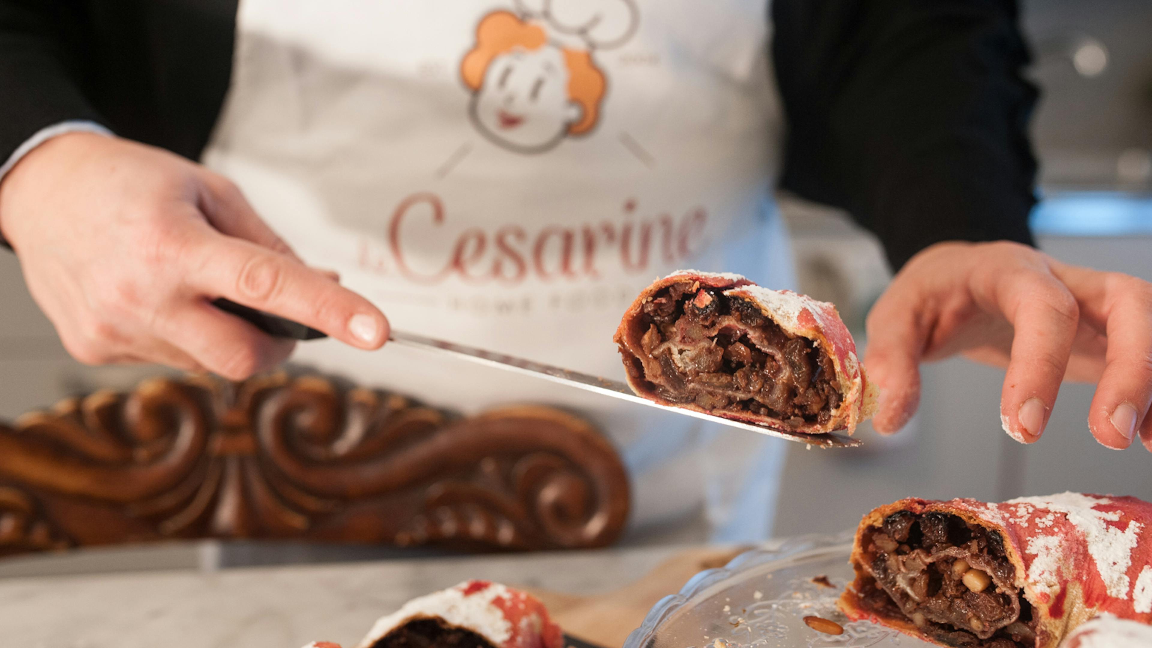 Cesarina cuts a slice of Rocciata di Foligno