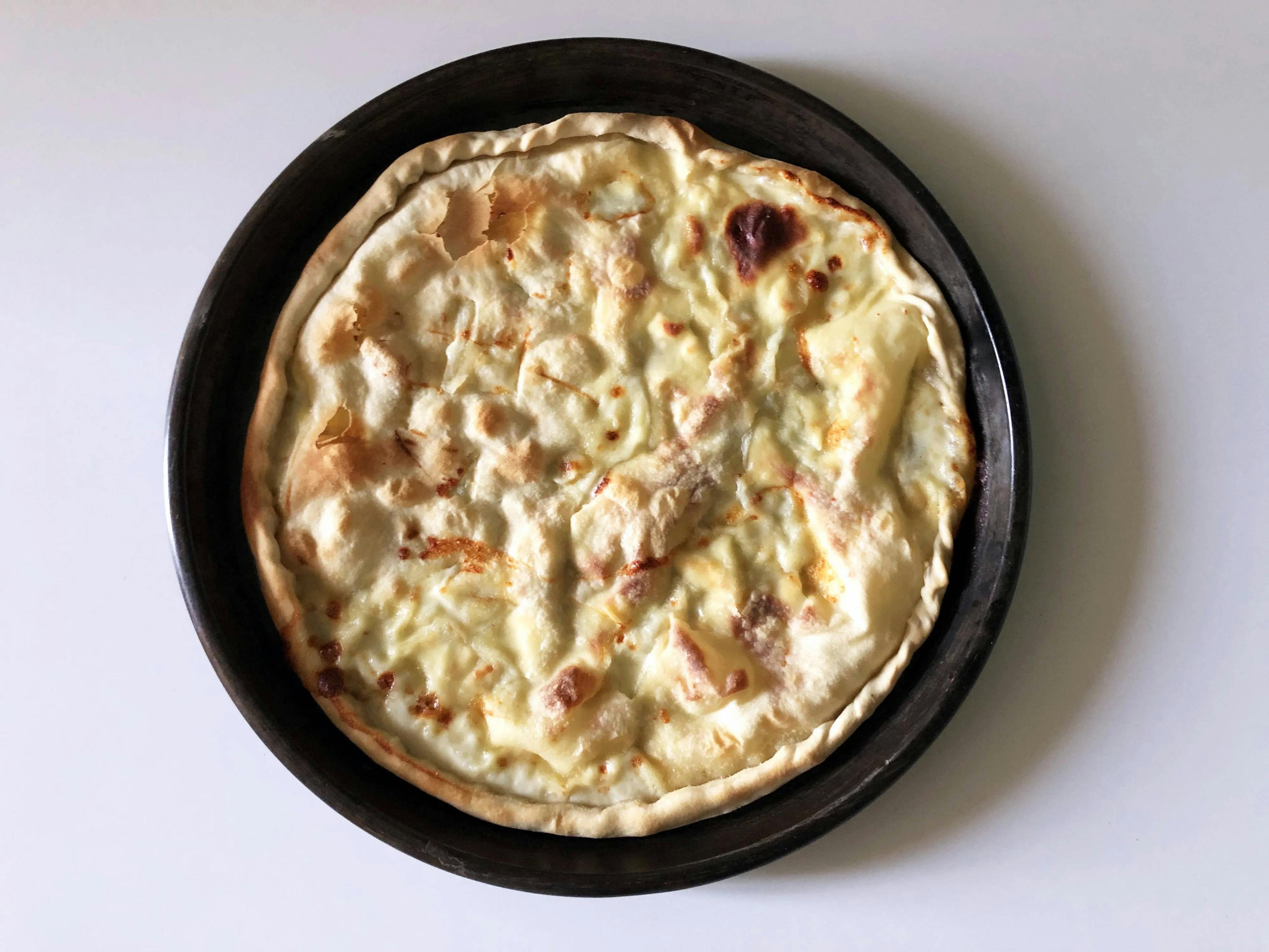 Genoese focaccia in a baking tray seen from above