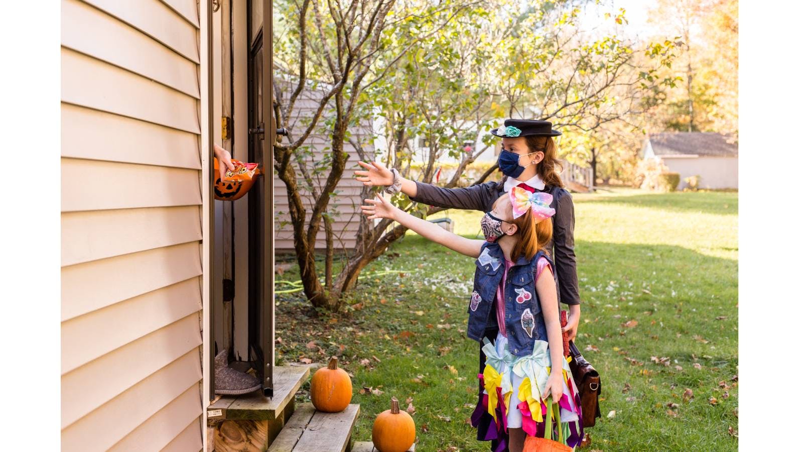 Children asking for candy on Halloween in the classic "trick or treat?" scenario